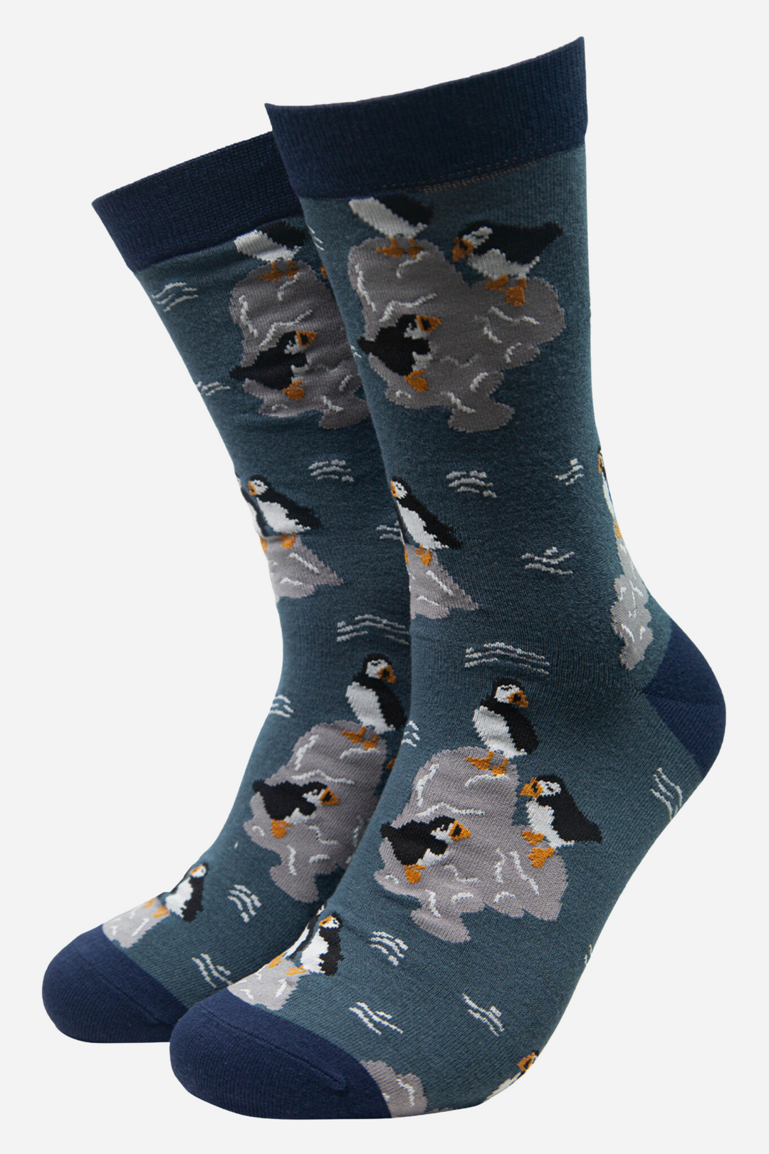 teal blue socks with a pattern of puffin birds sitting on grey rocks