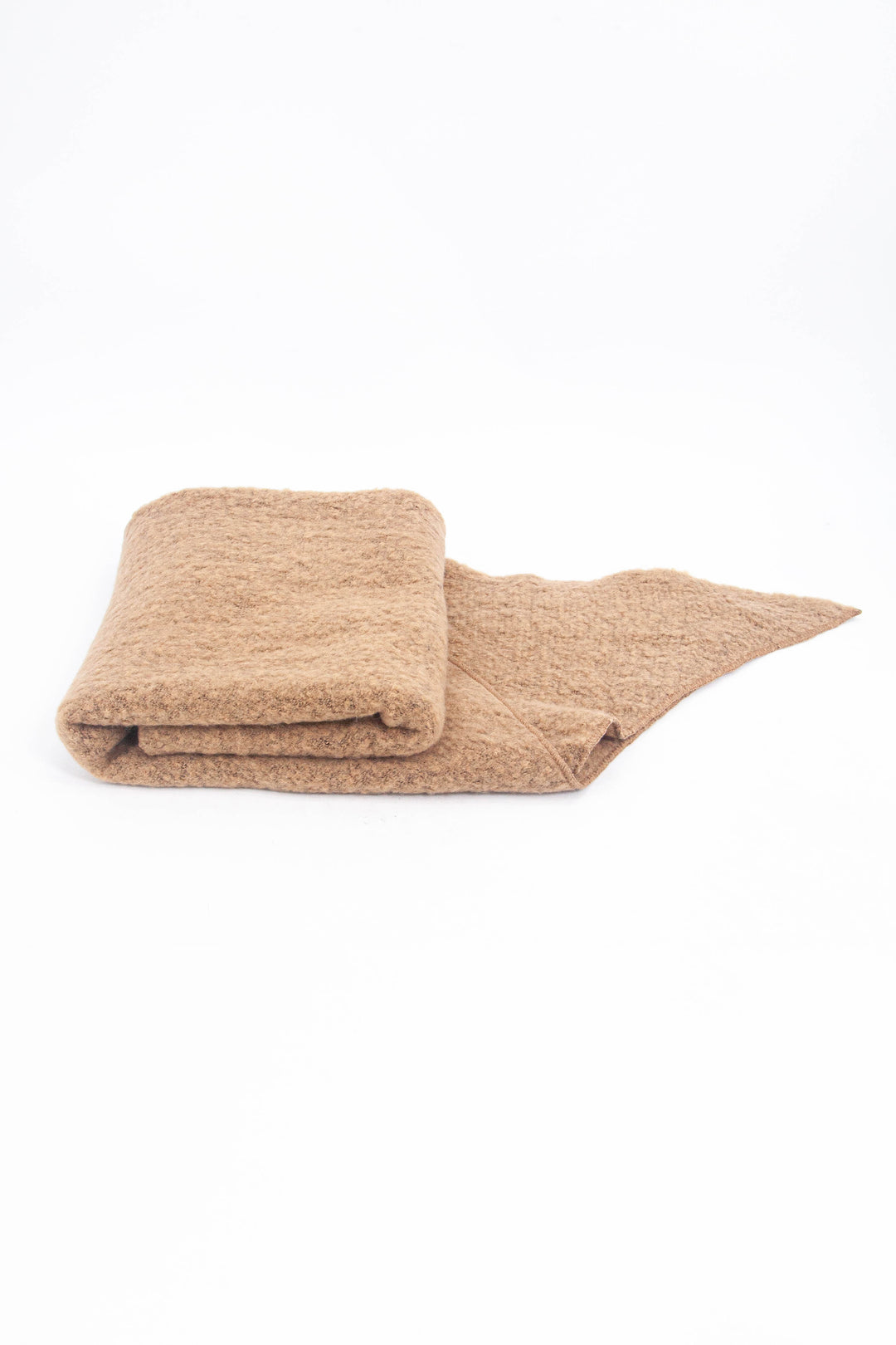close up of the scarf folded on a flat surface, showing the soft textured fabric