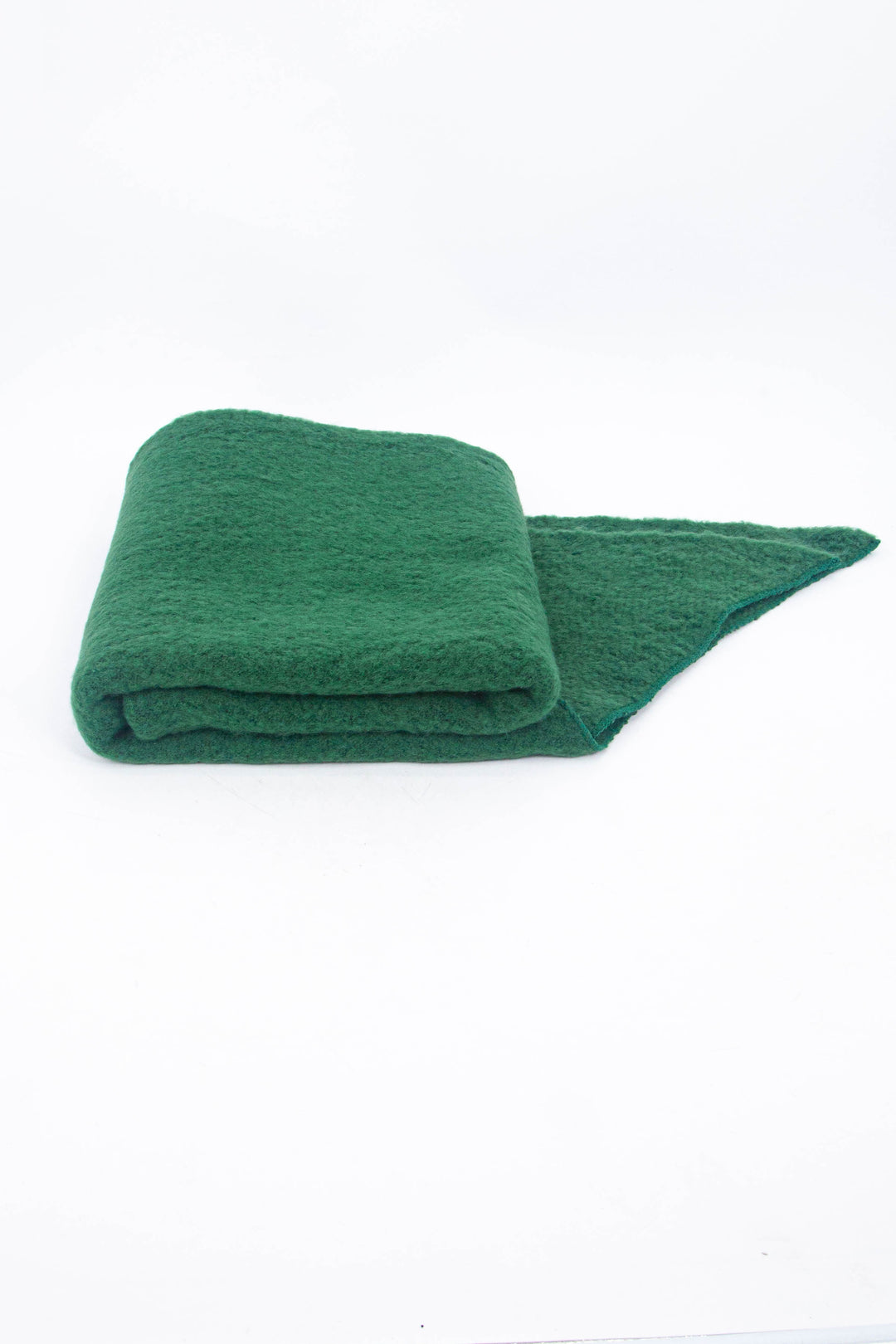 close up of the scarf folded on a flat surface, showing the soft textured fabric