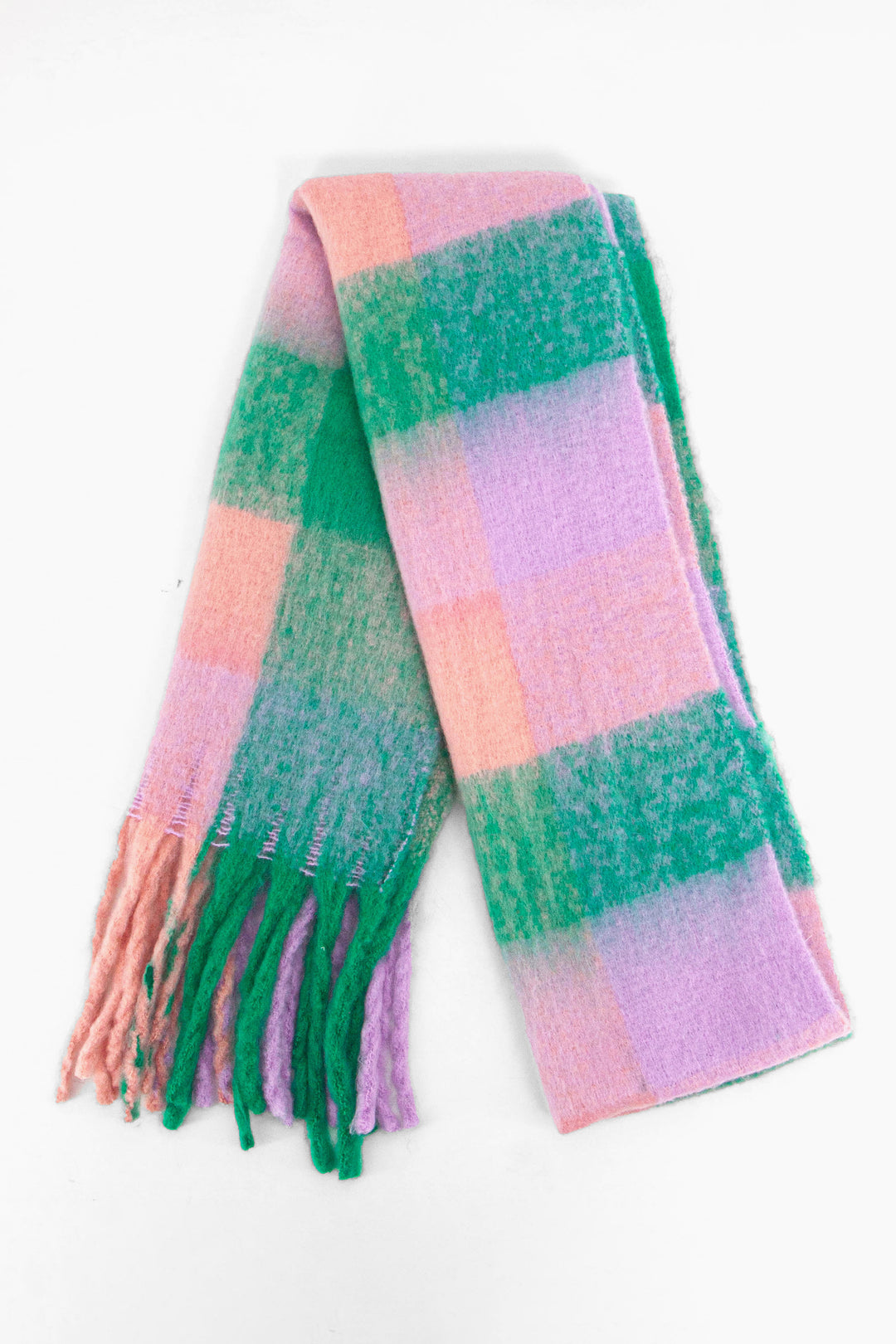 showing the scarf folded while laying flat, the multi colour square block pattern is highlighted. there are pink, green and lilac tones visible in the design.