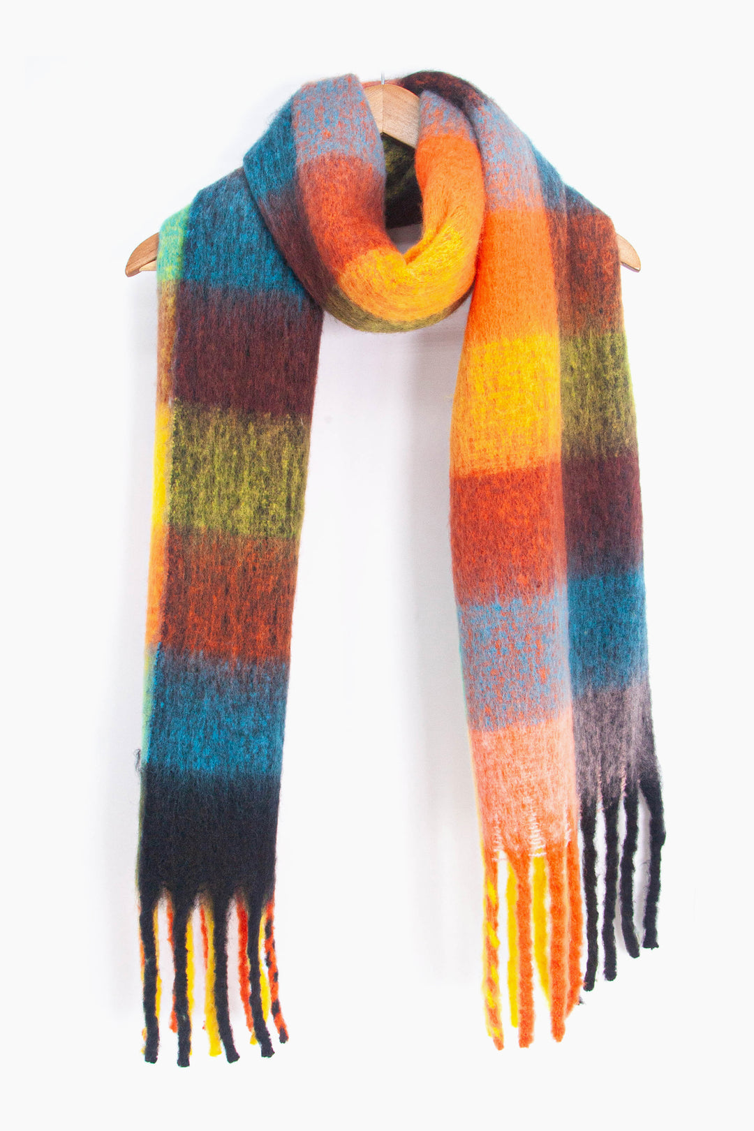 showing the multicoloured square colour block winter scarf draped around a coat hanger, showing how it would look when worn.