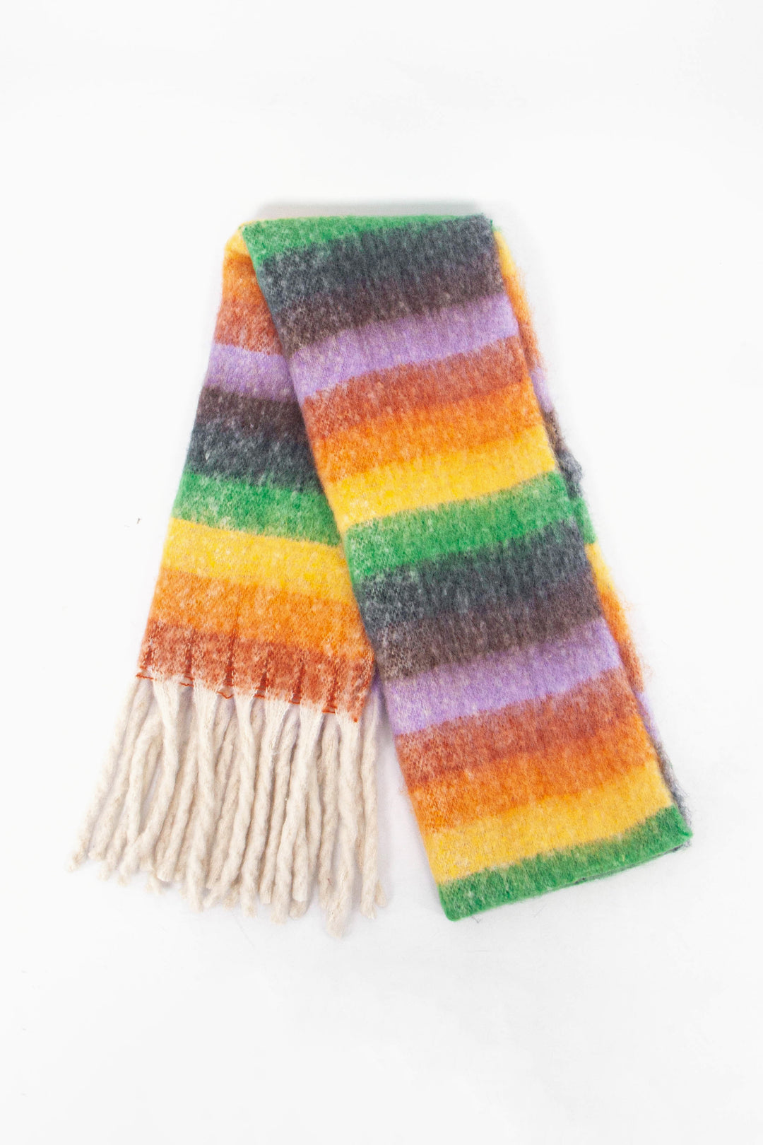 showing the scarf folded while laying flat, the multi colour stripe pattern is highlighted. there are yellow, orange, green, black and lilac tones visible in the design.