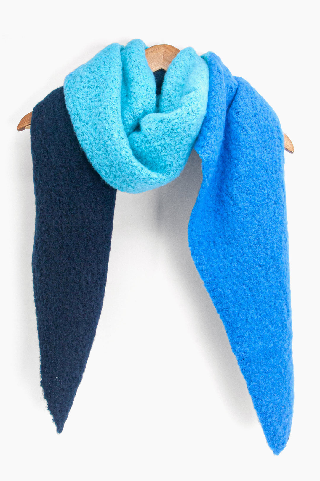 showing the royal blue and navy blue colour block scarf draped around a coat hanger showing how it would look when worn