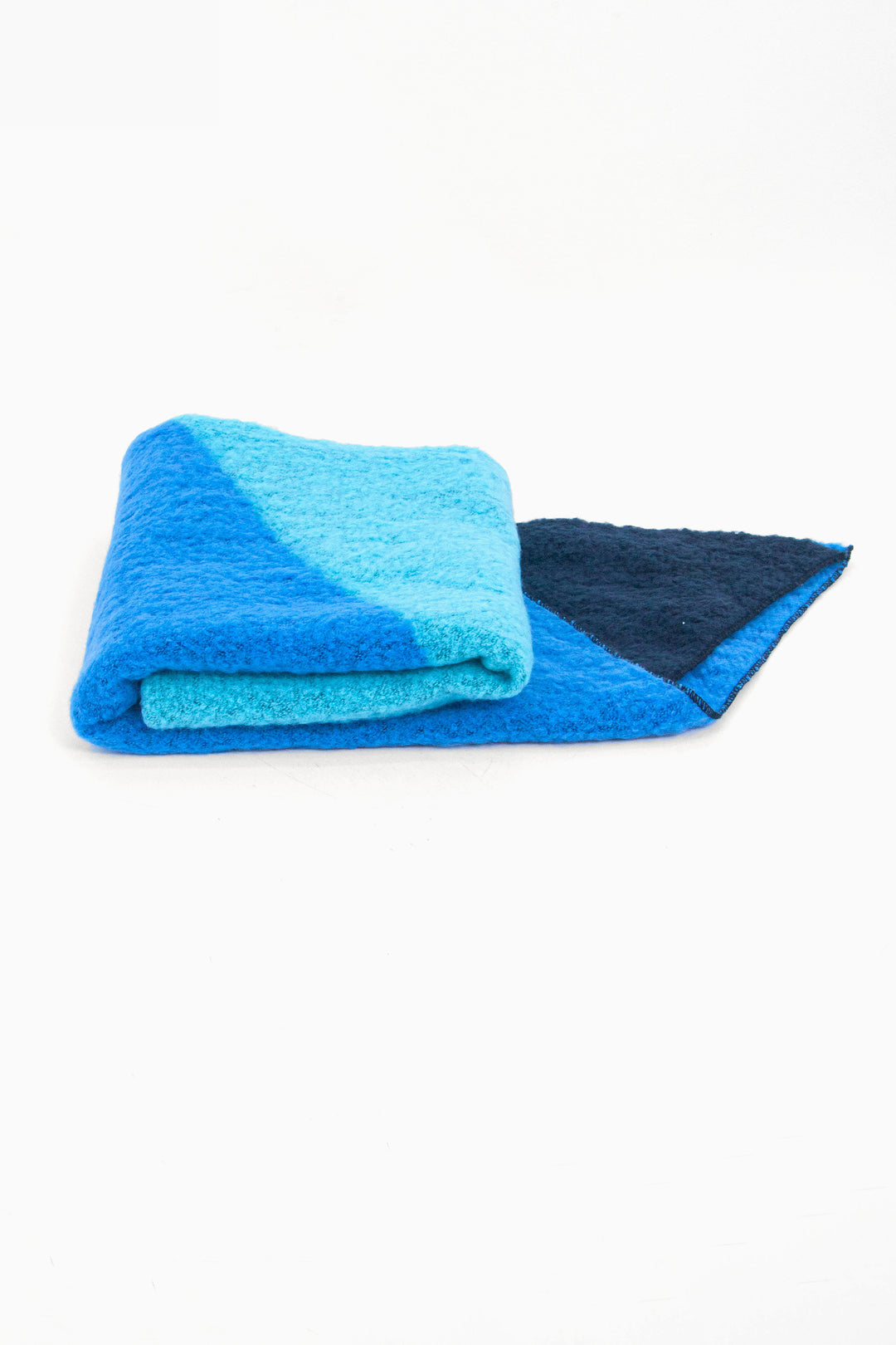 side view of the scarf when folder, showing the texture and thickness of the material. this scarf is warm and winter weight