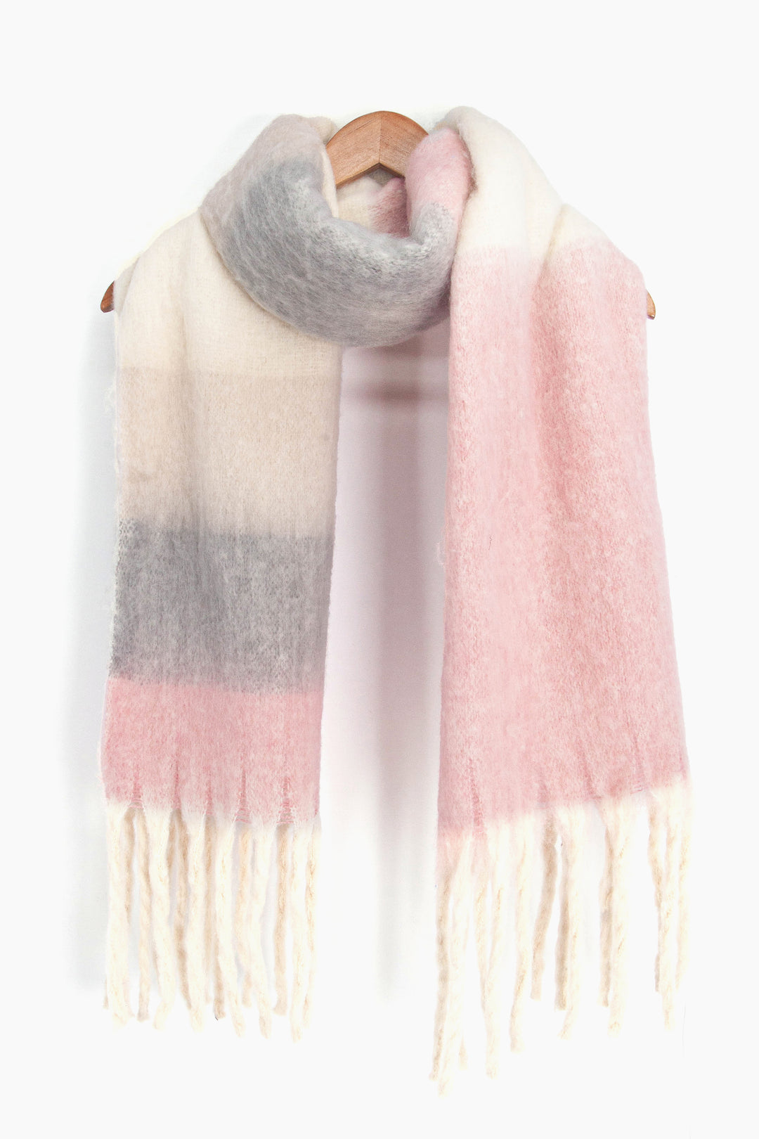 showing the grey, pink, and cream colour block winter scarf draped around a coat hanger, showing how it would look when worn.