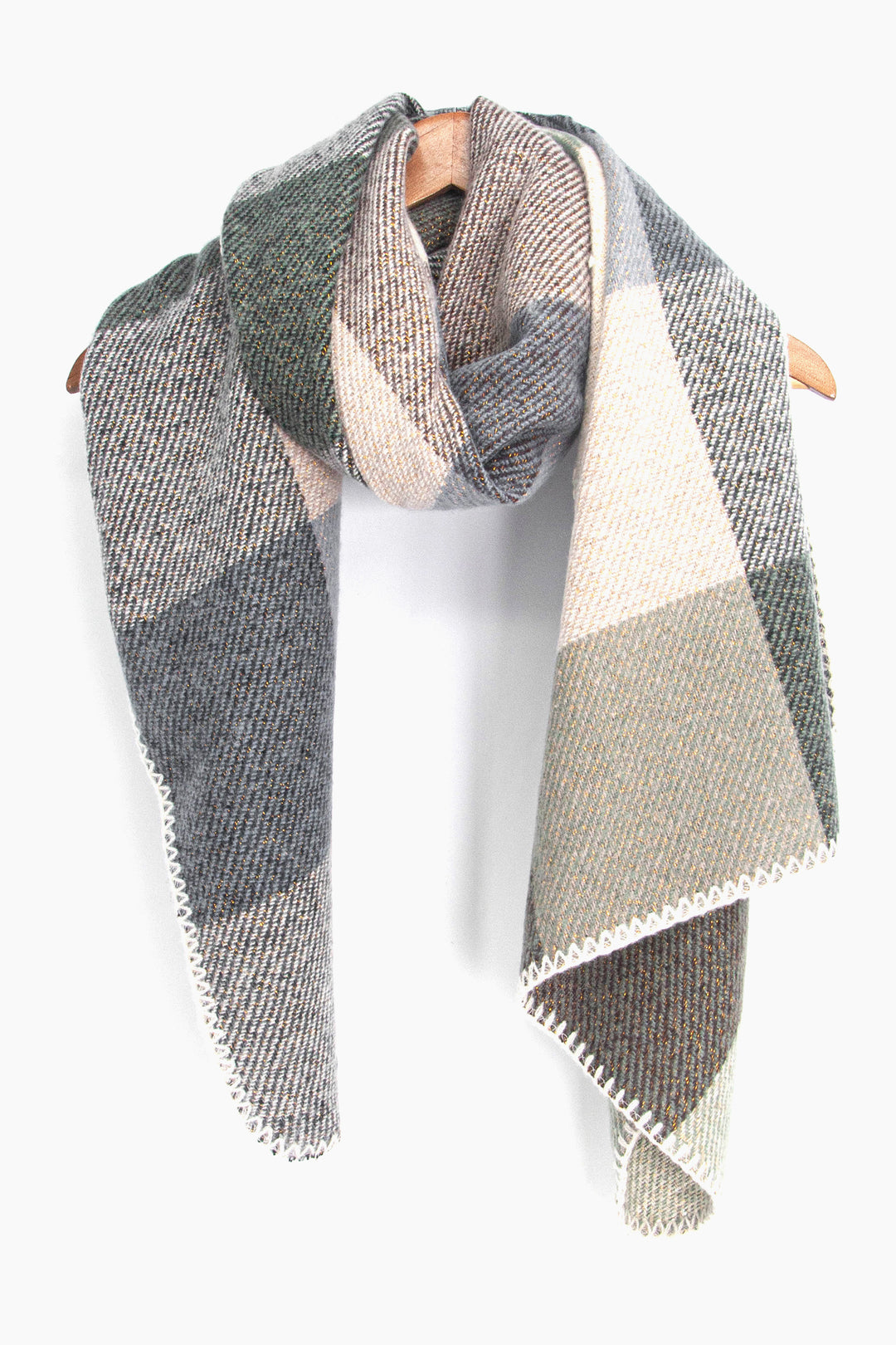 showing the grey blue and neutral square check pattern winter scarf draped around a coat hanger