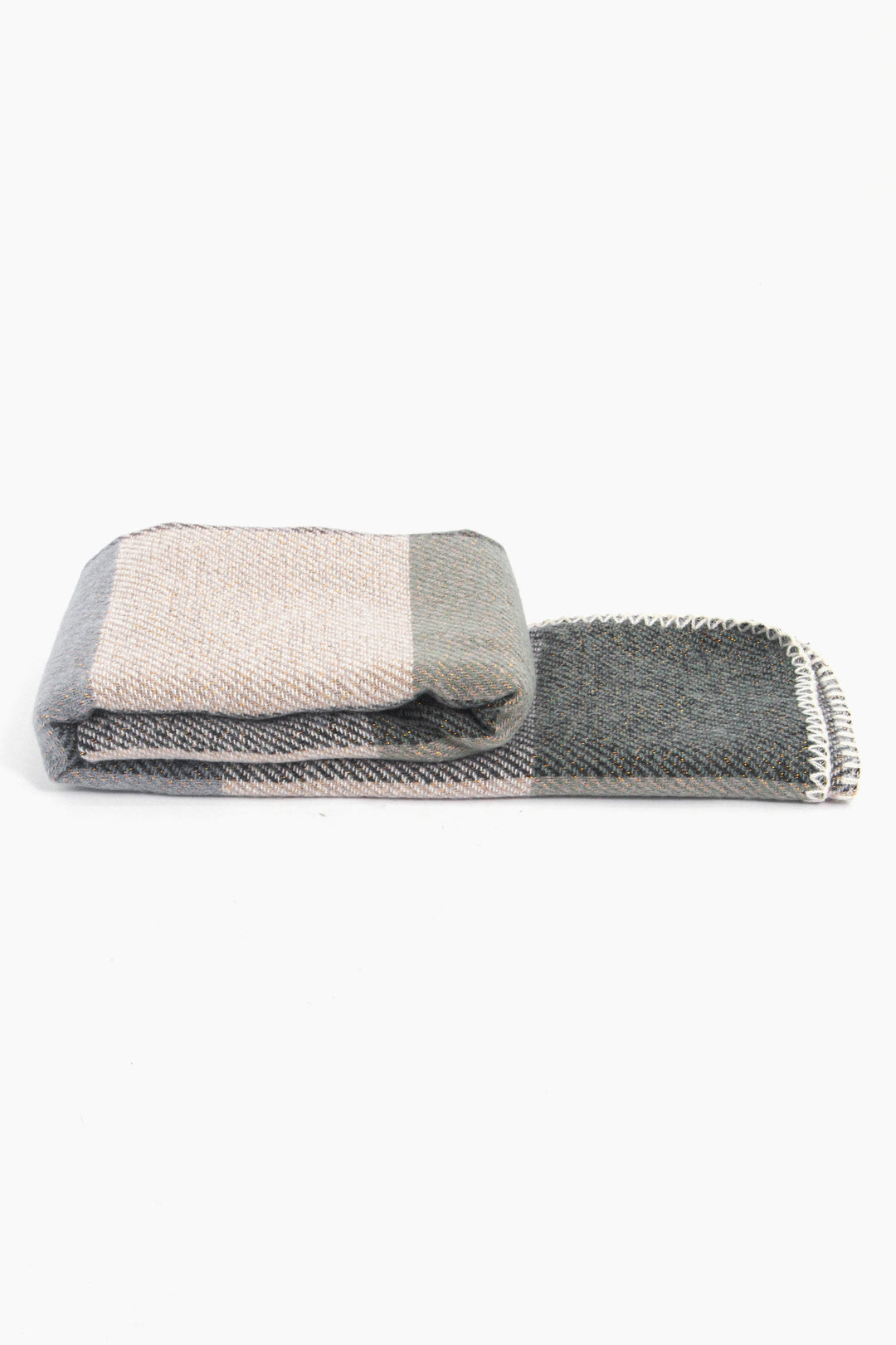 side view of the scarf when folder, showing the texture and thickness of the material. this scarf is warm and winter weight