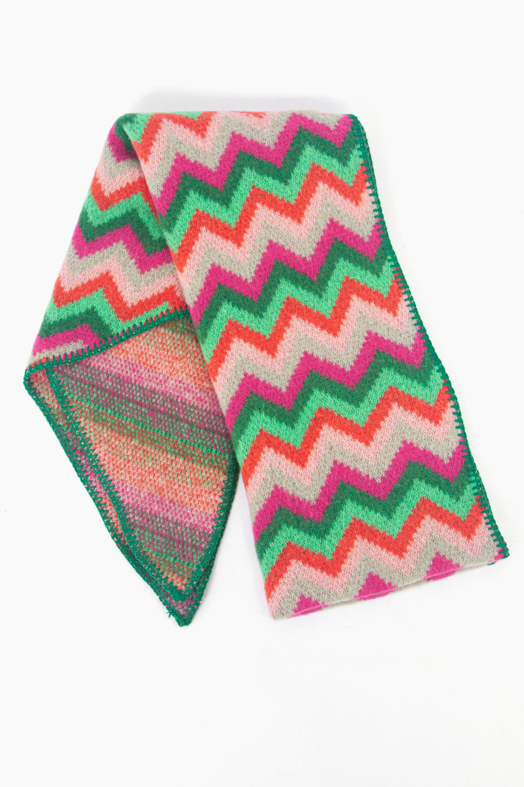 showing the scarf folded while laying flat, the multicoloured zig zag pattern is clearly highlighted.