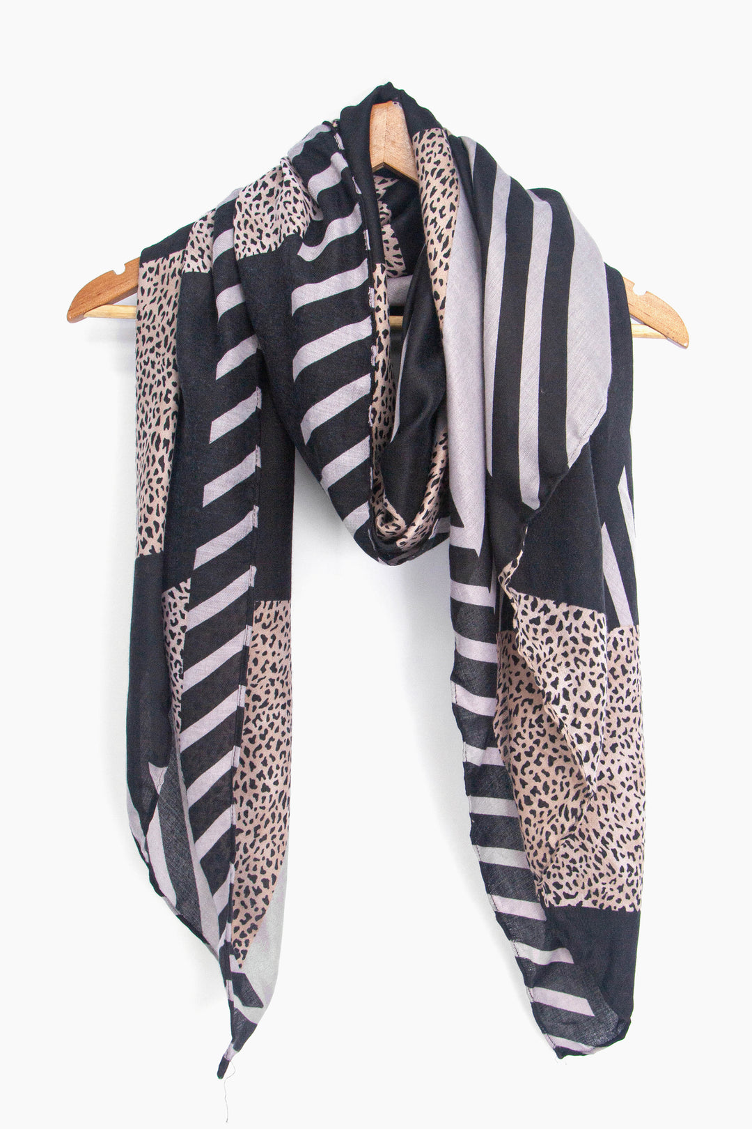 showing the scarf draped around a coat hanger, showing the all over pattern and how it would look when worn