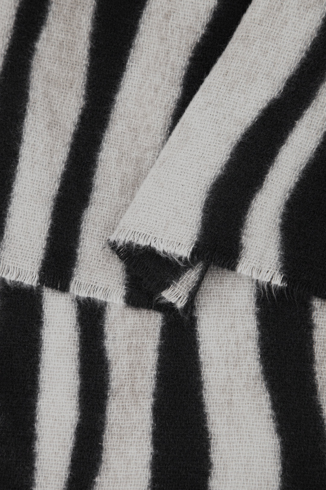 close up of the soft viscose fabric, the cream and black colourways are clearly visible