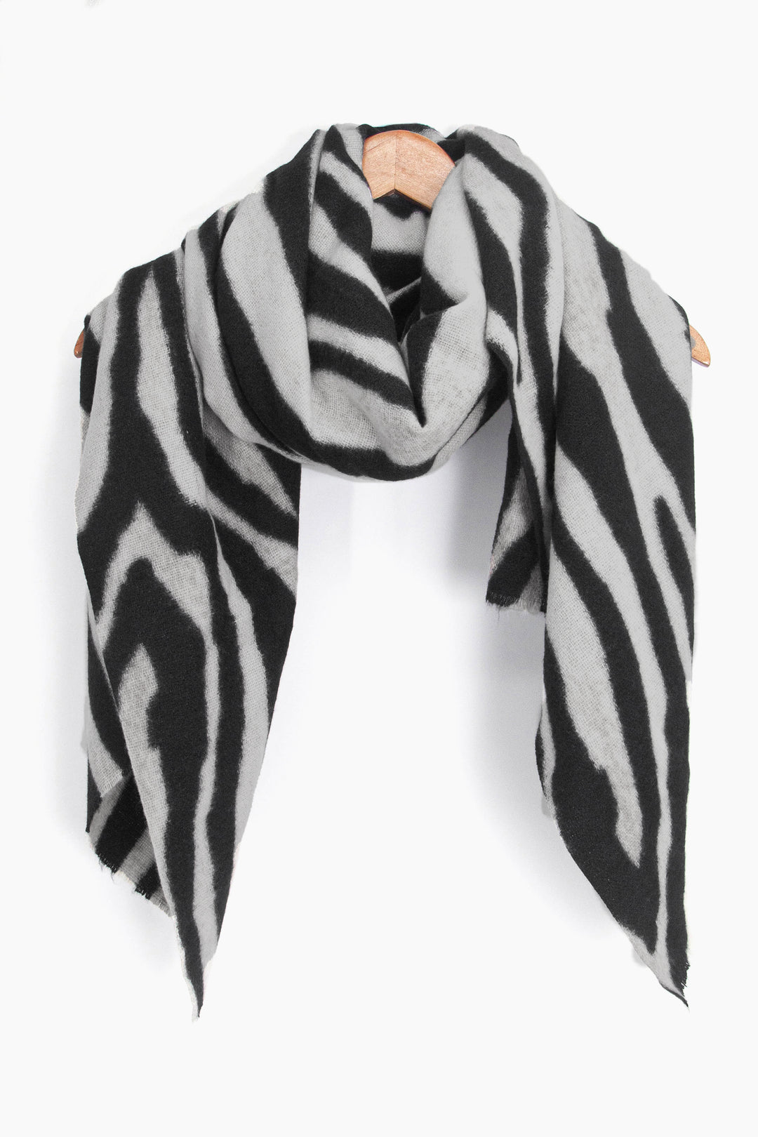 showing the scarf draped around a coat hanger, showing the all over pattern and how it would look when worn