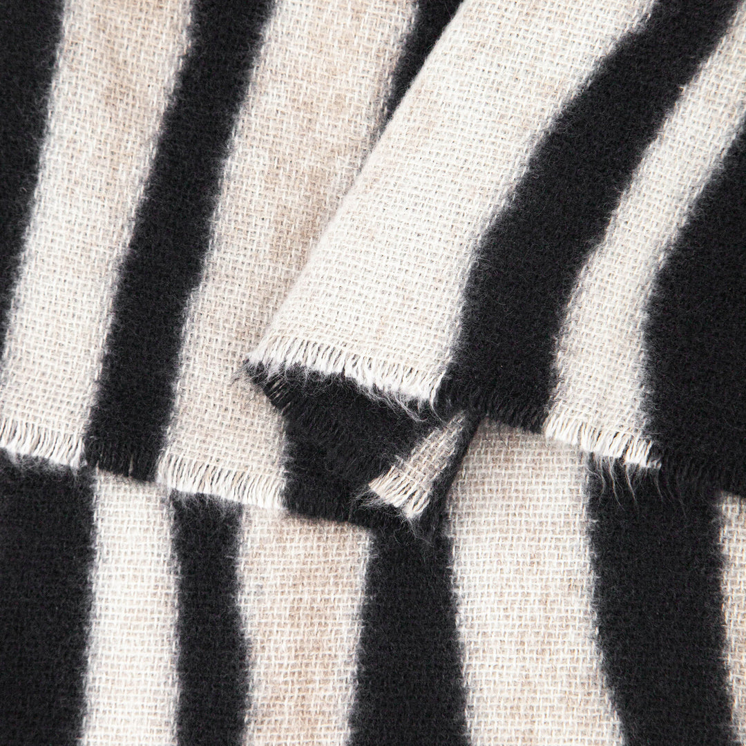 close up of the soft viscose fabric, the cream and black colourways are clearly visible