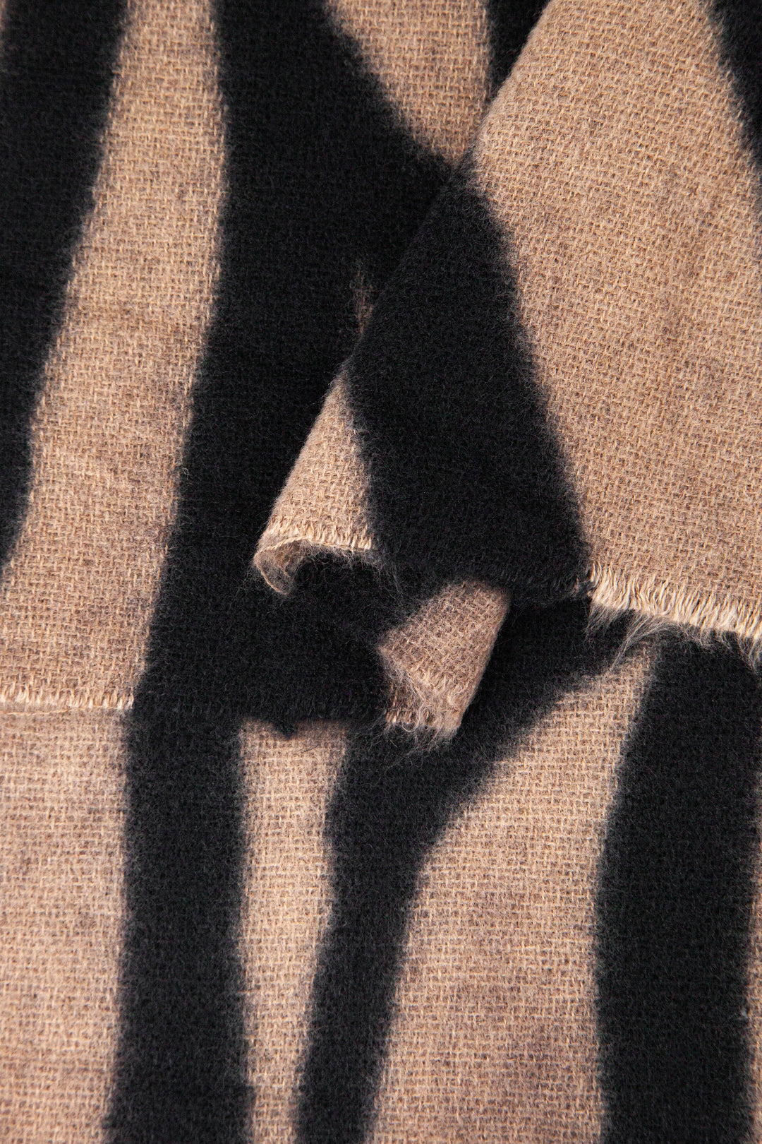 close up of the soft viscose fabric, the neutral and black colourways are clearly visible