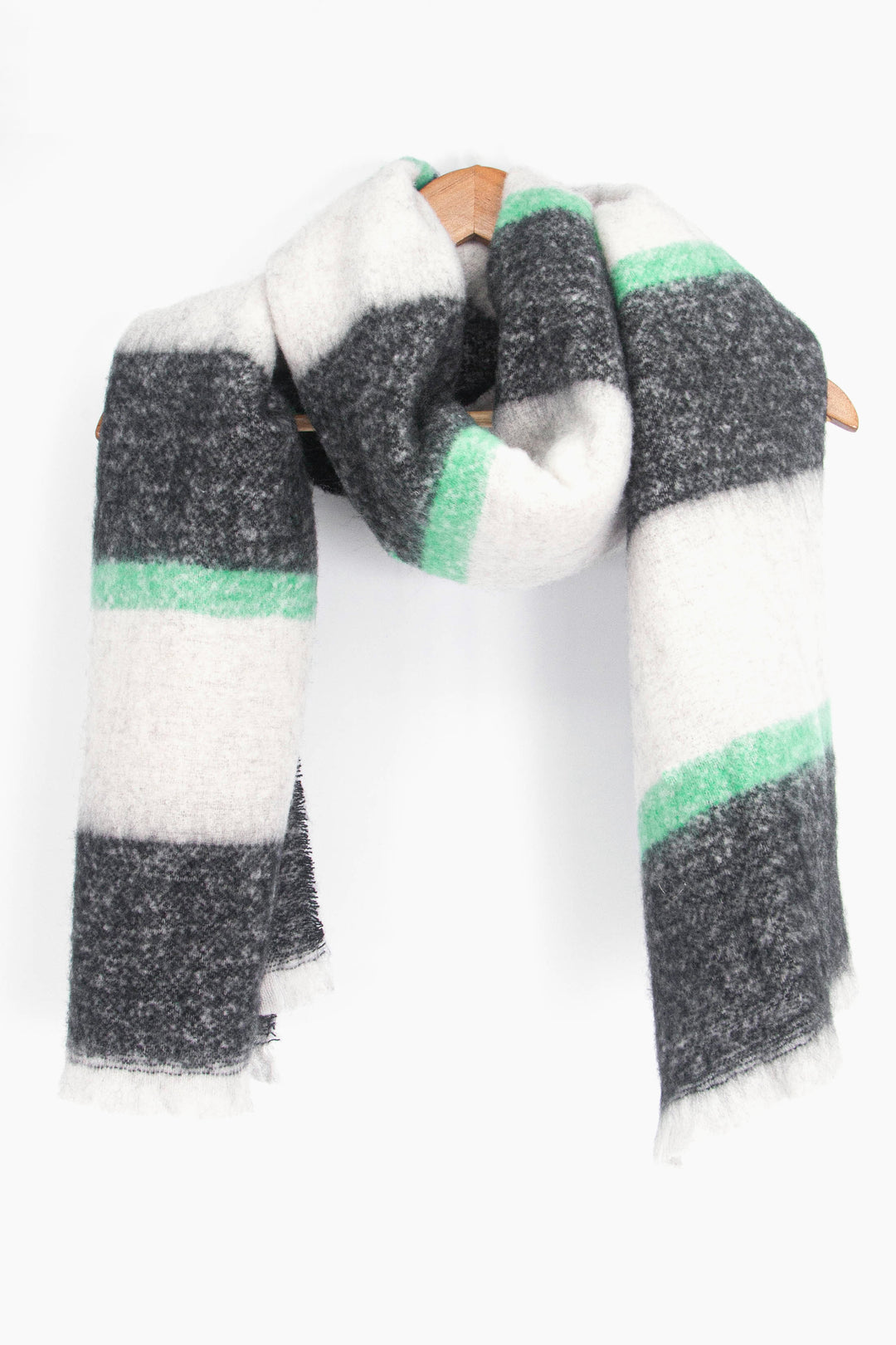 showing the scarf draped around a coat hanger, showing the all over pattern and how it would look when worn