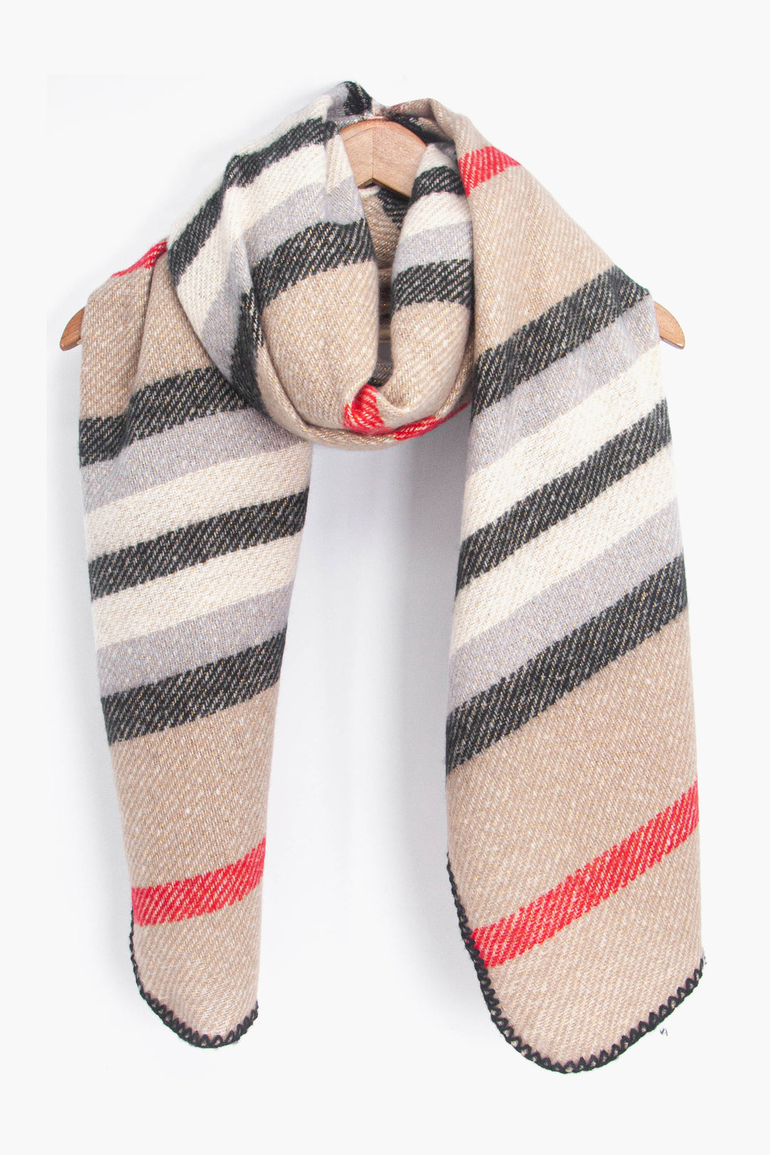 showing the cream stripe pattern winter scarf draped around a coat hanger, showing how it would look when worn.