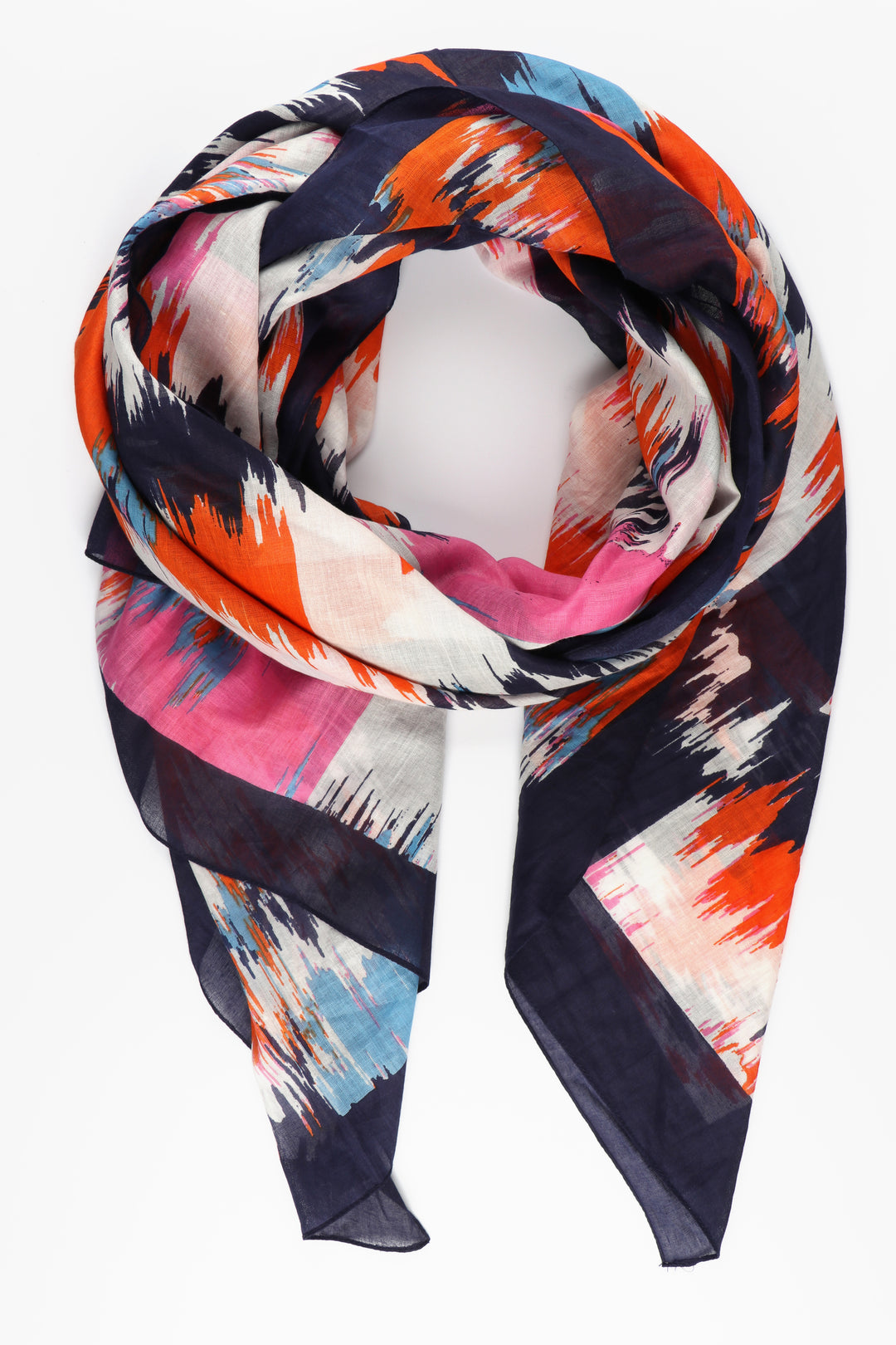 abstract pattern cotton scarf with a navy blue border and an all over pattern featuring orange, pink and white abstract chevrons