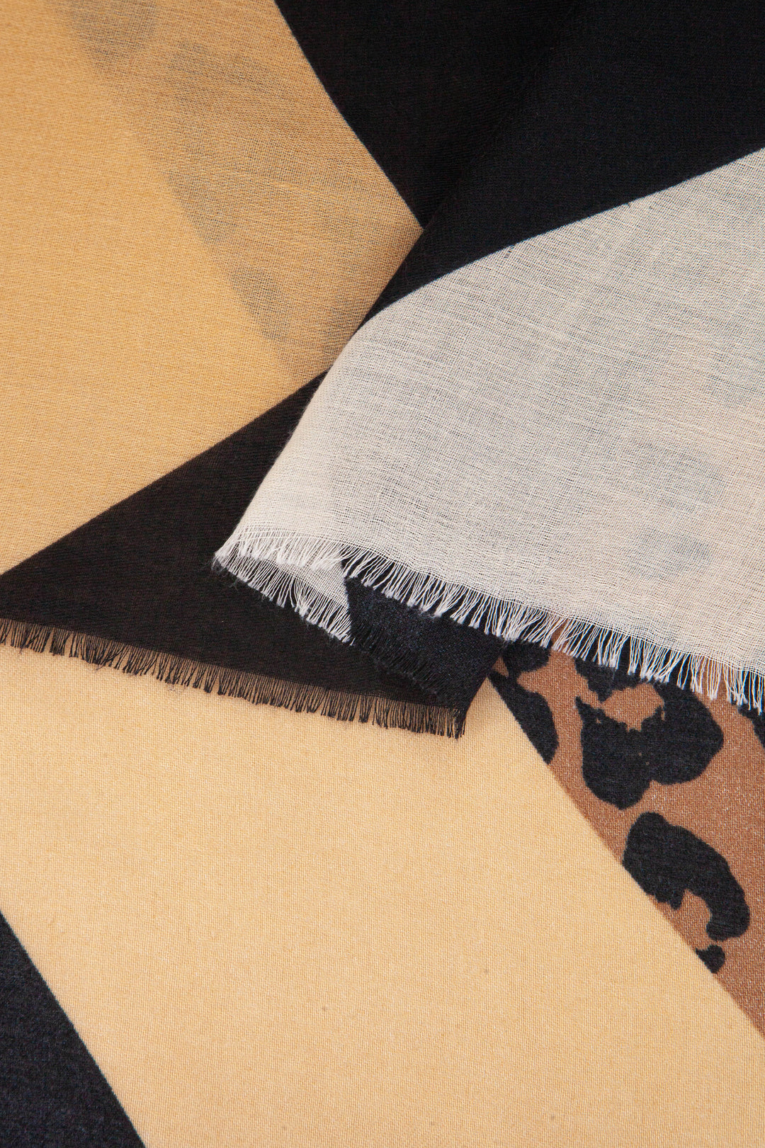 close up of the soft viscose fabric, the neutral and black colourways are clearly visible
