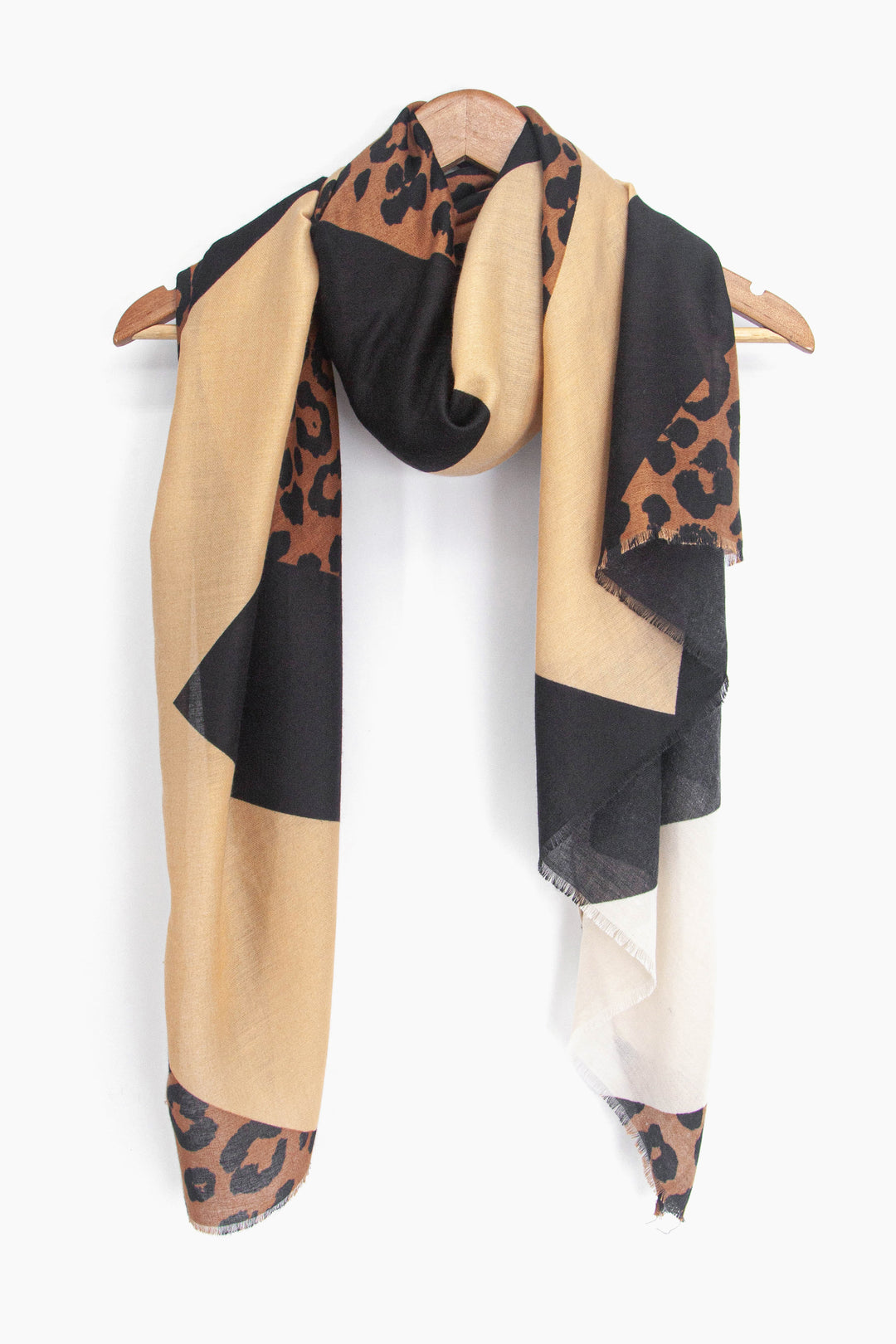 showing the black and neutral lightweight scarf draped around a coat hanger, showing how it would look when worn.
