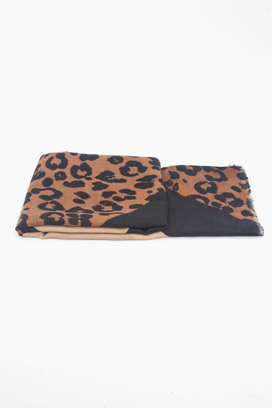 side view of the scarf when folded, showing the texture and thickness of the material. this scarf is lightweight