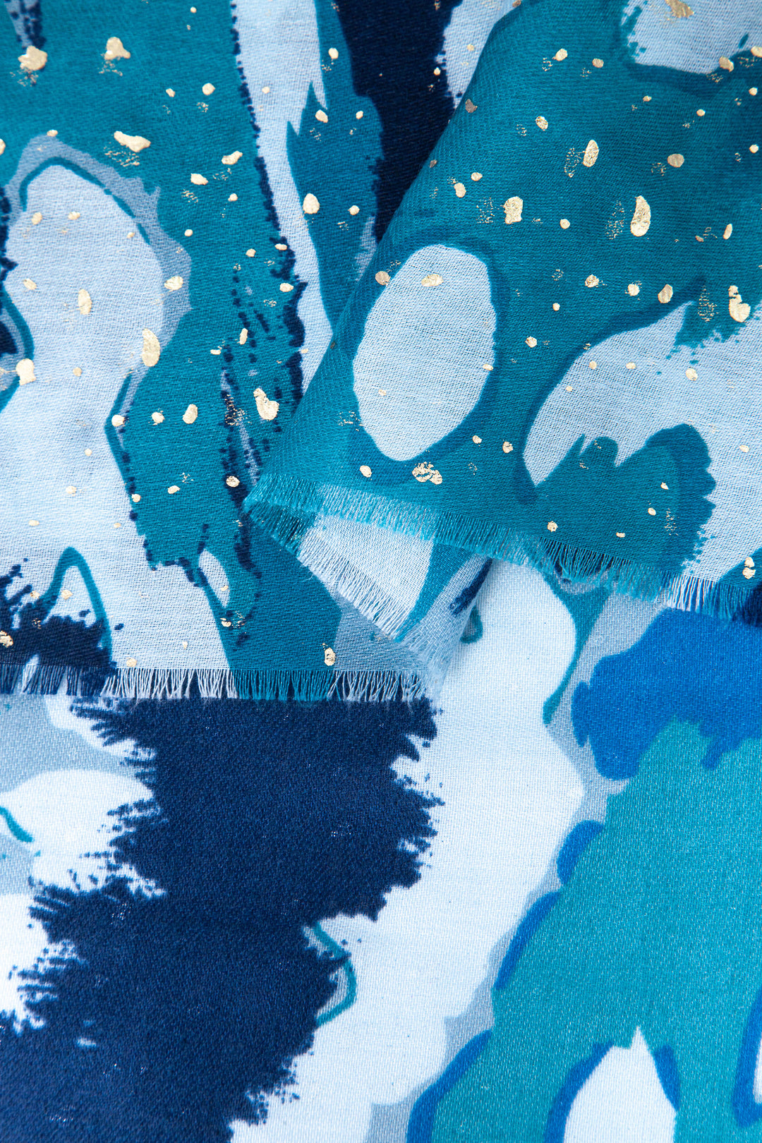 close up of the soft viscose fabric, the blue colourways and gold foil speckle pattern is clearly shown