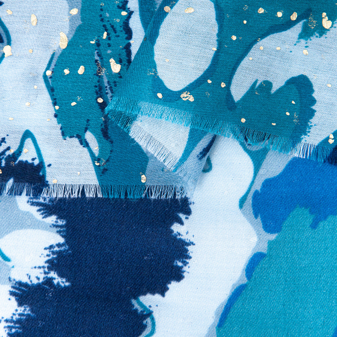 close up of the soft viscose fabric, the blue colourways and gold foil speckle pattern is clearly shown