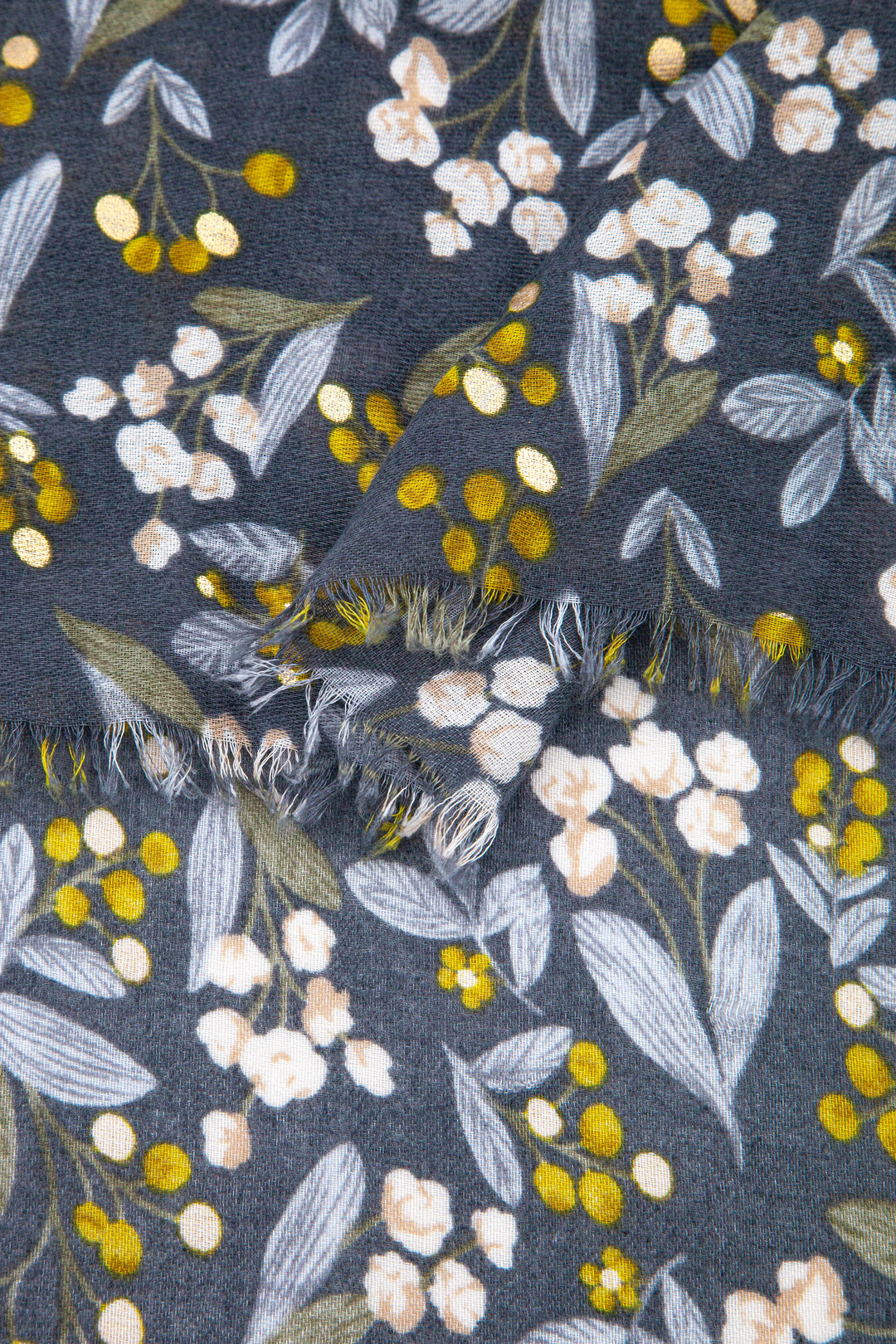 close up of the soft viscose fabric, the grey and yellow colourways and gold foil speckle pattern is clearly shown