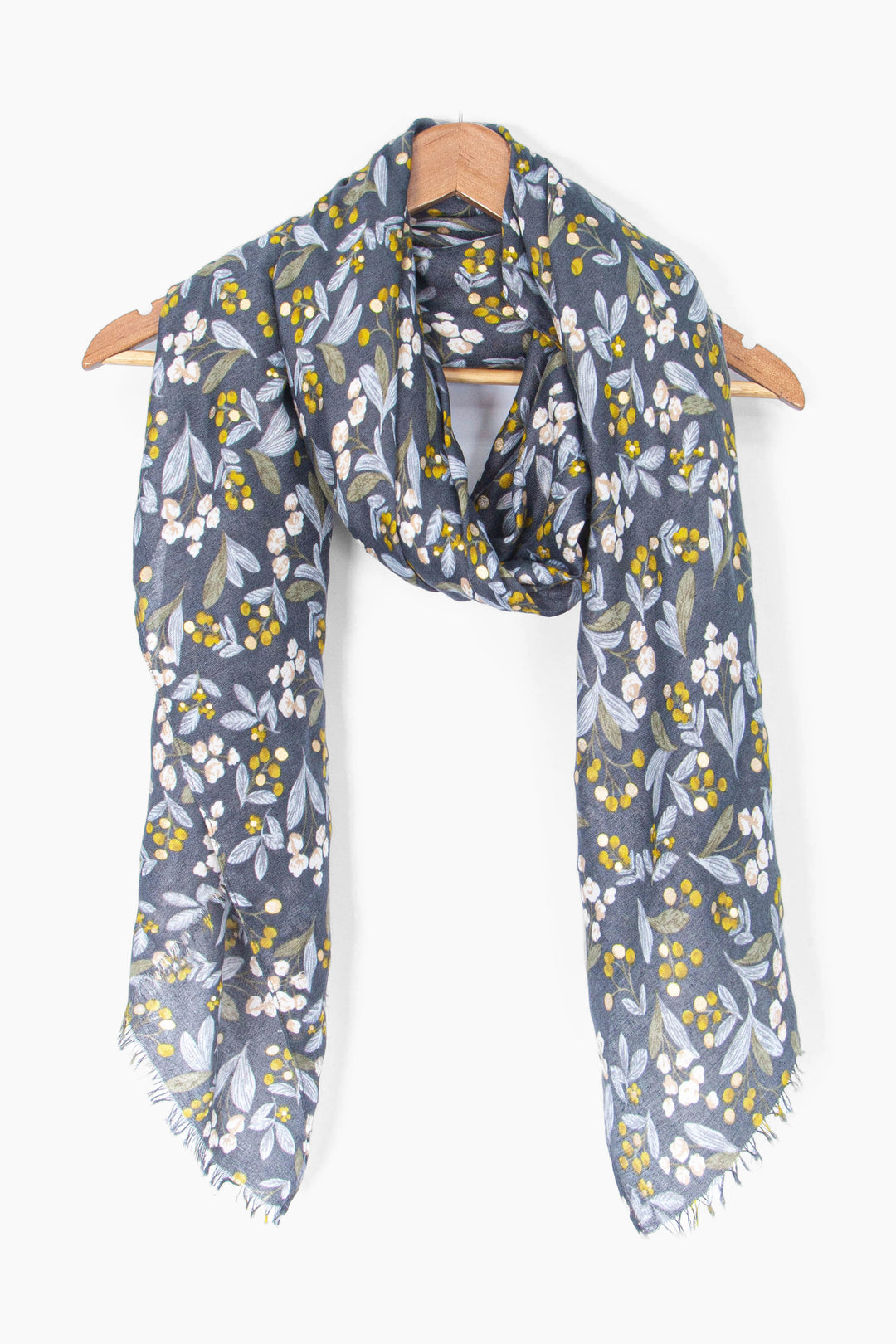 showing the scarf draped around a coat hanger, showing the all over pattern and how it would look when worn