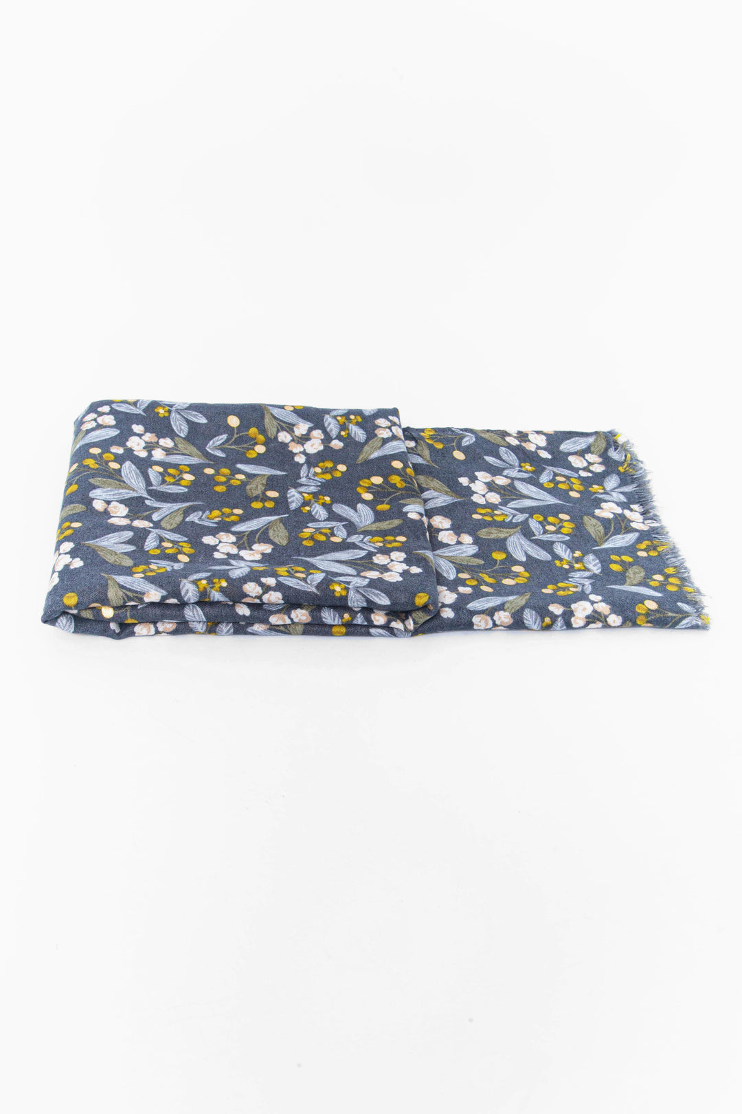 side view of the scarf when folded, showing the texture and thickness of the material. this scarf is lightweight