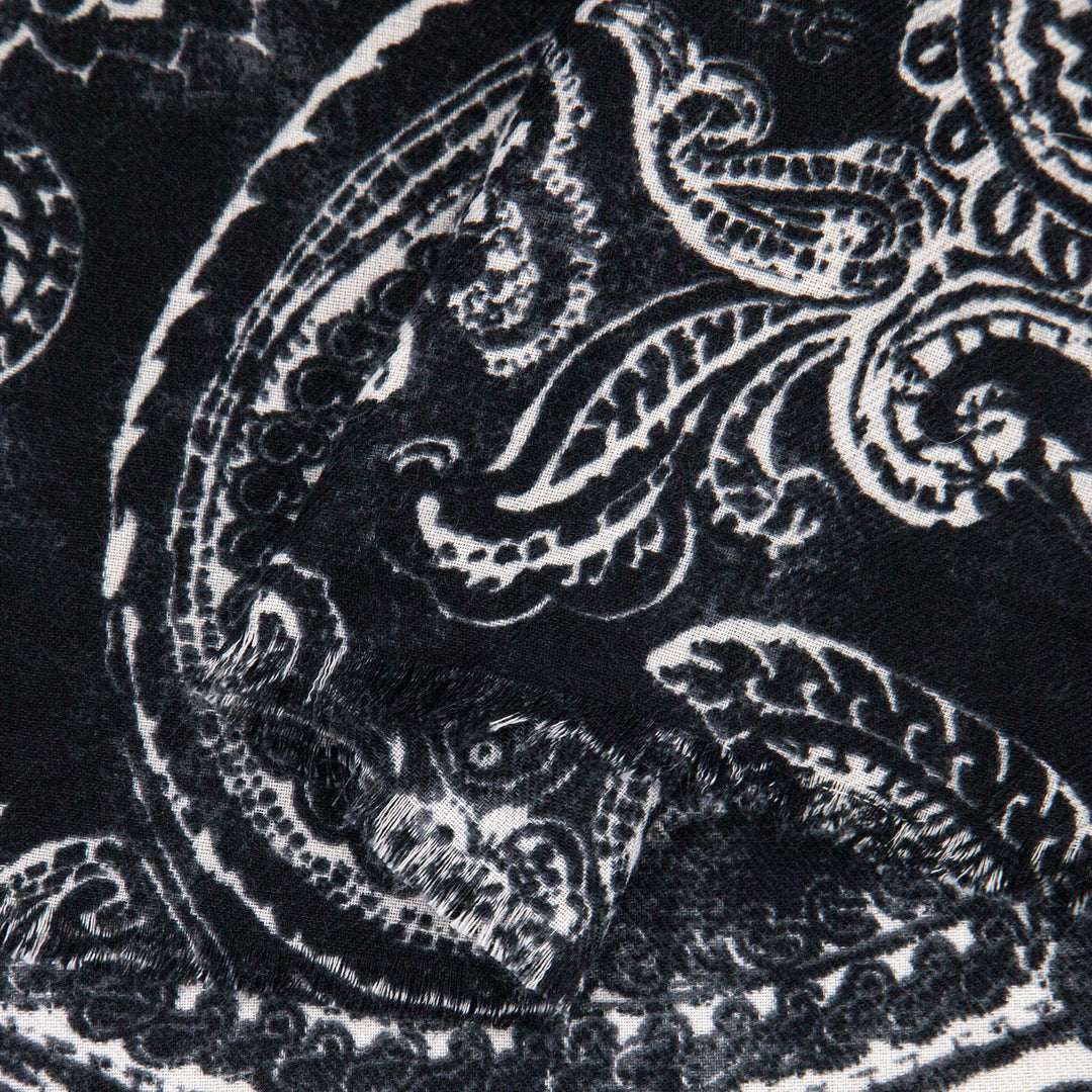 close up of the soft viscose fabric, the black and white paisley floral design is visible