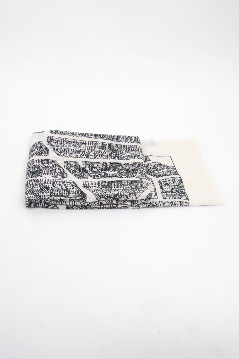 side view of the scarf when folded, showing the texture and thickness of the material. this scarf is lightweight