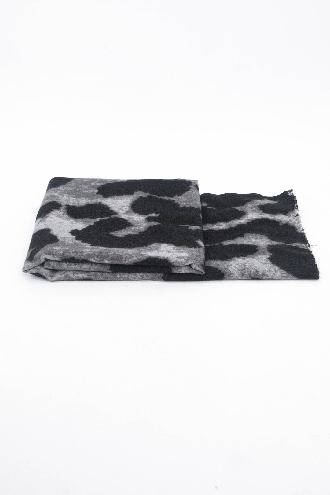 side view of the scarf when folded, showing the texture and thickness of the material. this scarf is lightweight