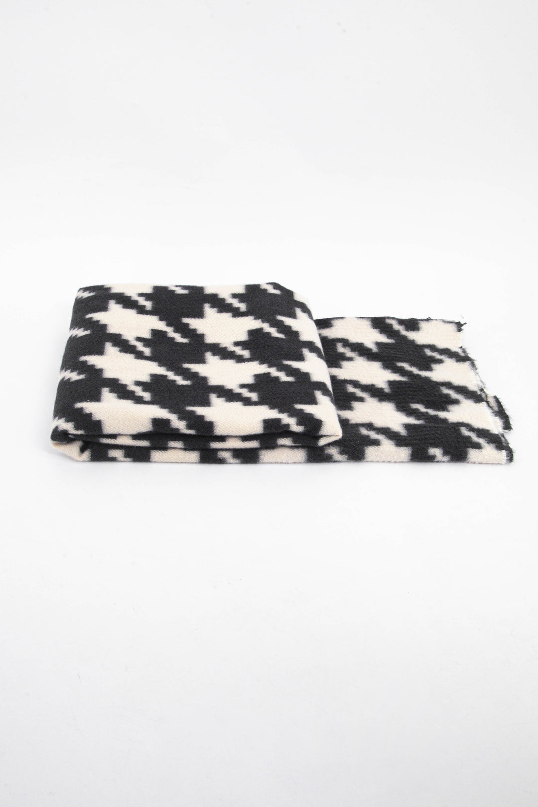 side view of the scarf when folded, showing the texture and thickness of the material. this scarf is midweight