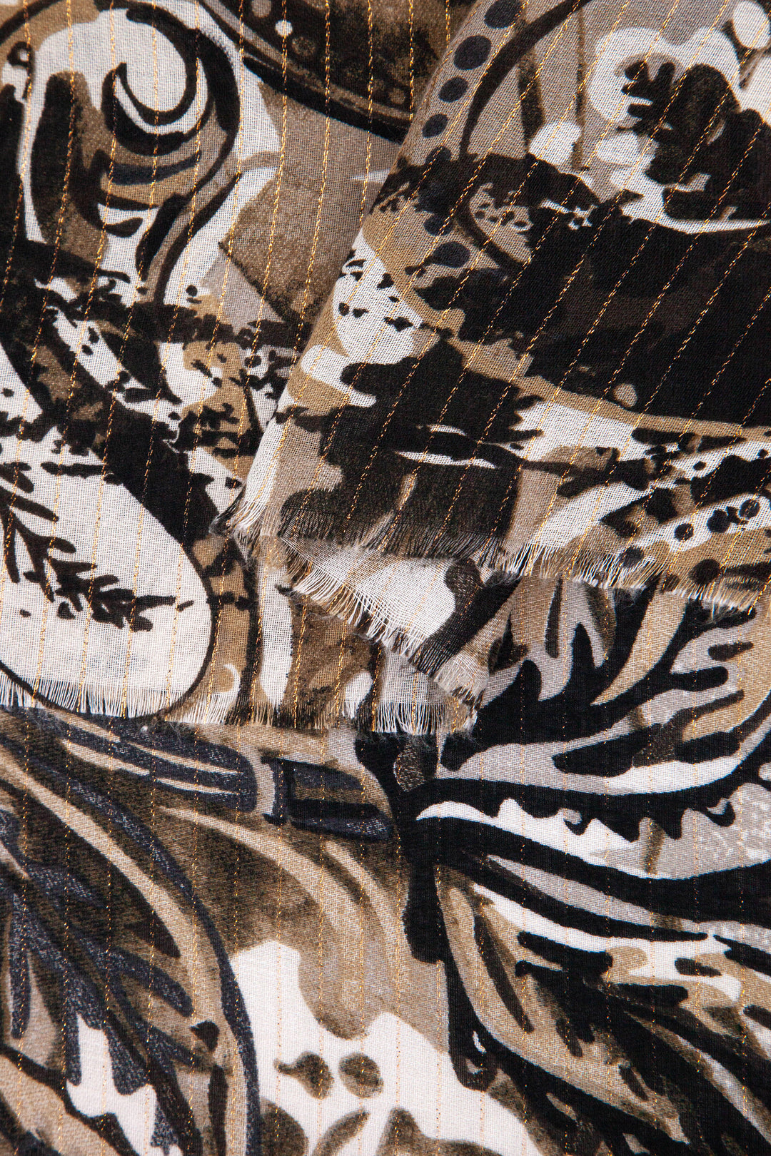 close up of the soft viscose fabric, the neutral colourway and gold metallic stripe are clearly visible
