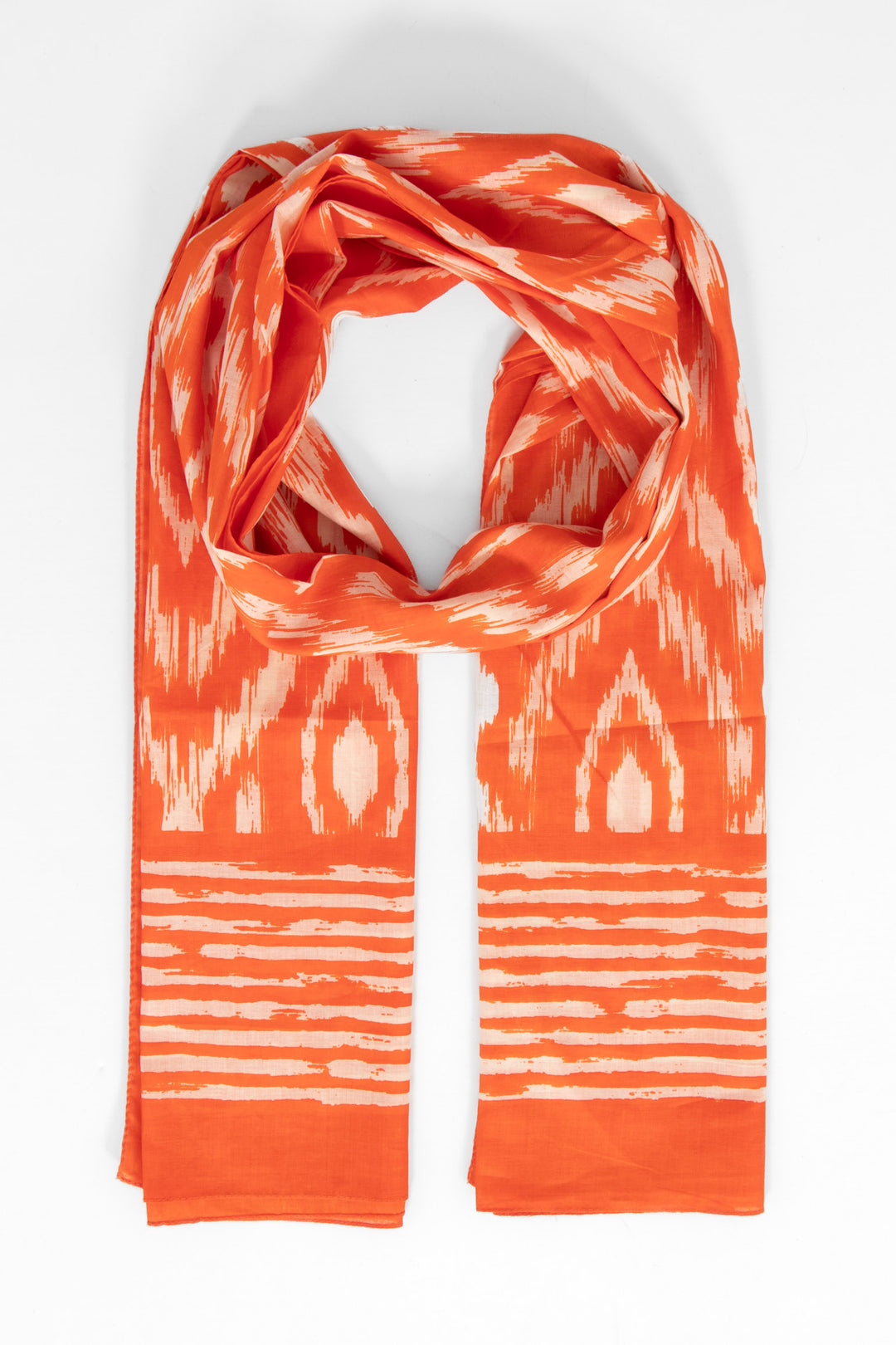 orange cotton lightweight aztec scarf. the scarf has an all over pattern and a large bordered edge.