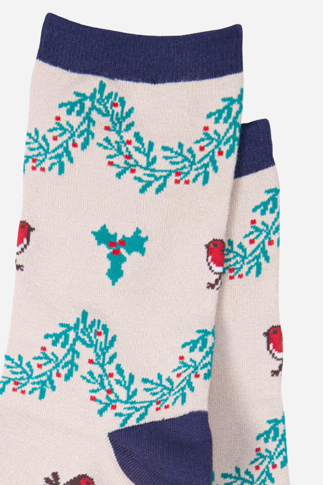 close up of the red robin and green holly design on the cream bamboo socks