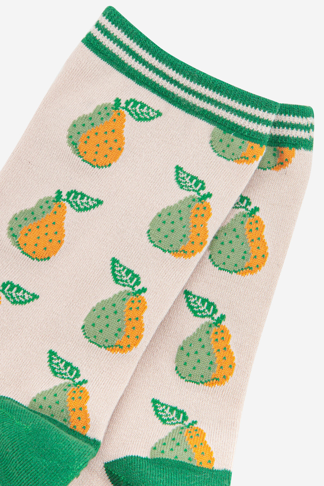 close up of the green and yellow pear fruit print and striped cuff on the bamboo socks