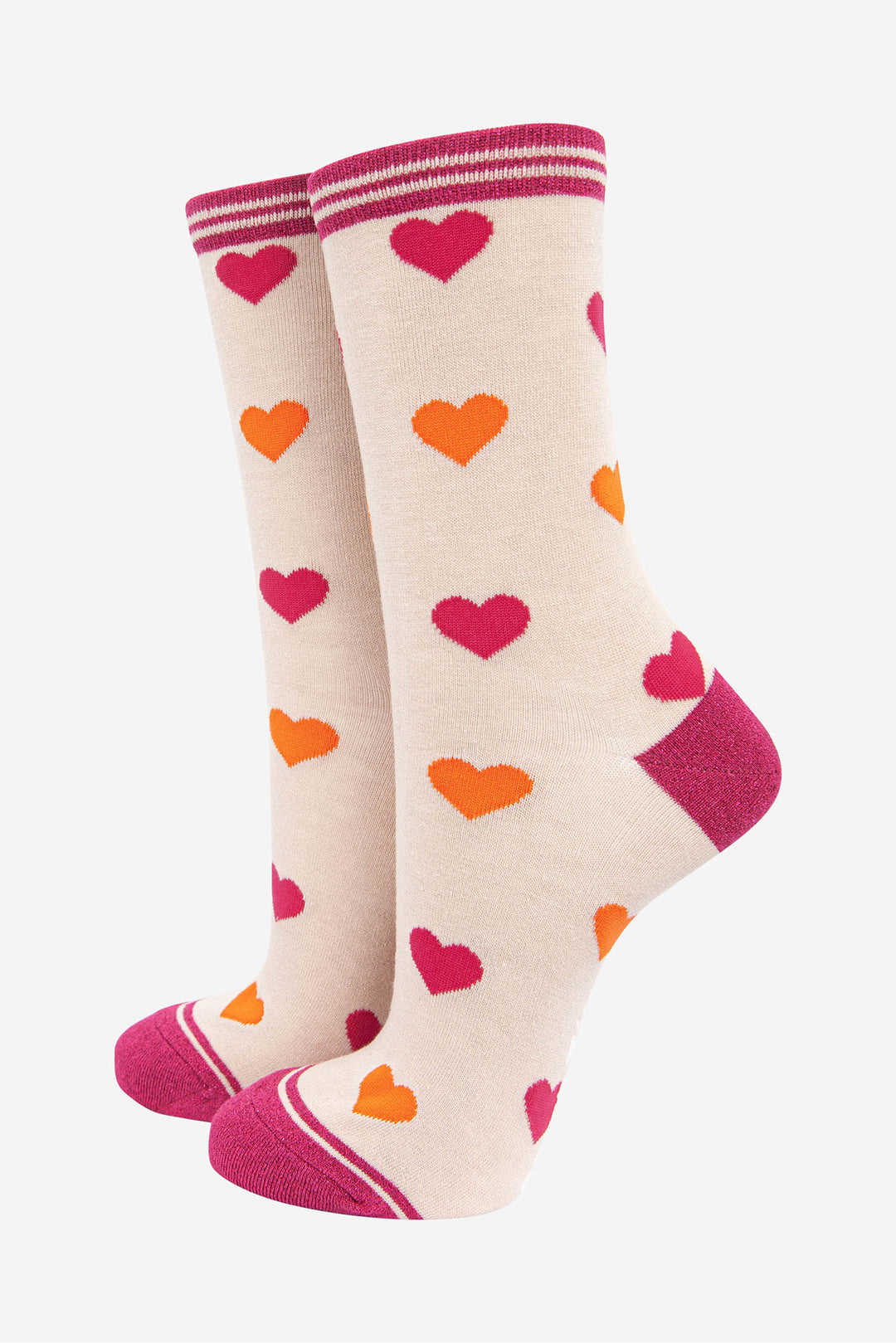 cream ankle socks with an all over pattern of pink and orange love hearts with a pink glitter toe, heel and cuff