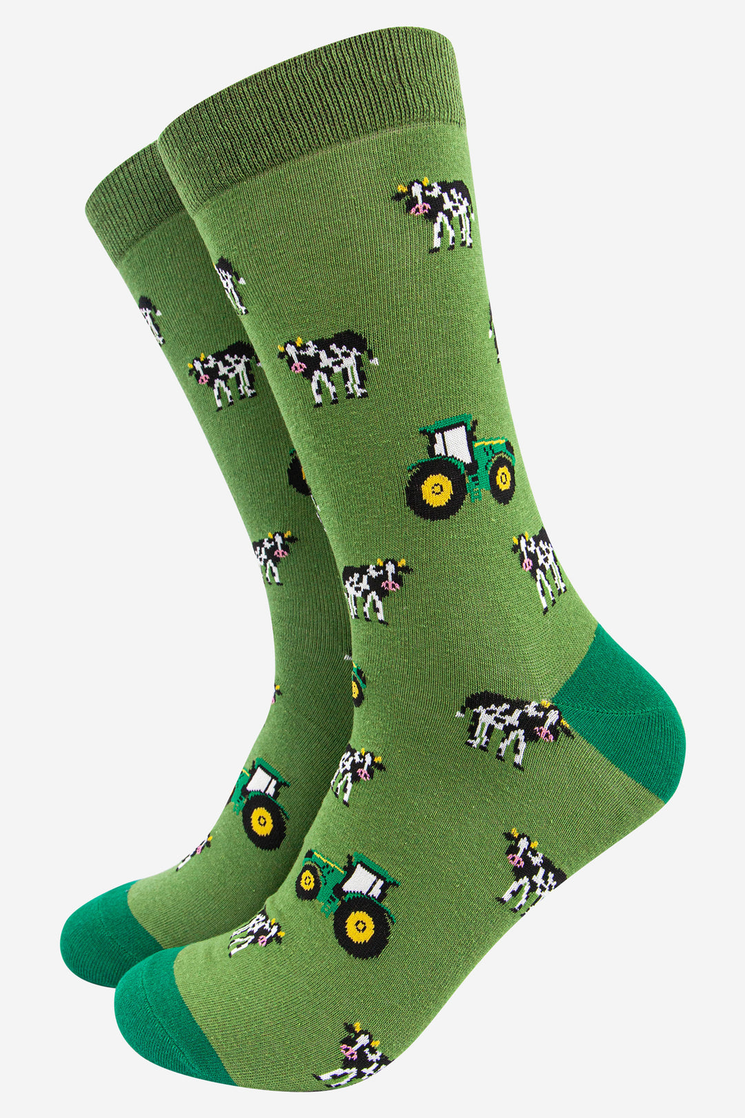 green dress socks with an all over pattern of green tractors and black and white cows
