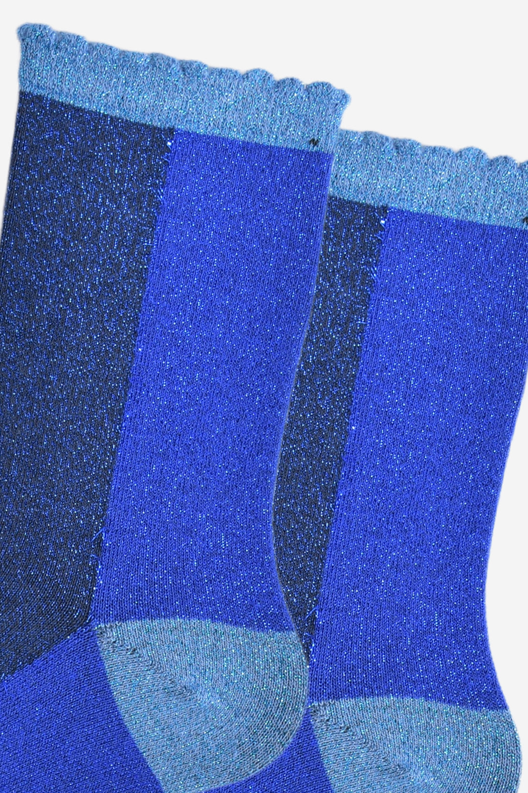 close up of the blue colour block glitter socks, there are two distinct colour blocks, one royal blue , one navy blue the socks have an all over glitter sparkle