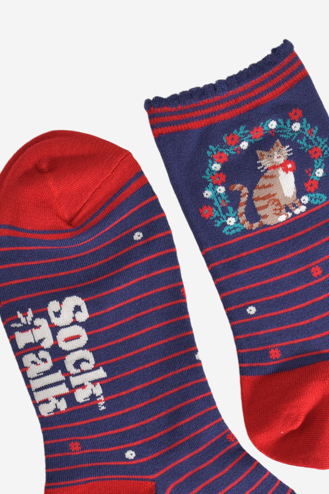 close up of the toe and cuff, the toe is red and the cuff is navy blue with a scalloped edge and red stripes