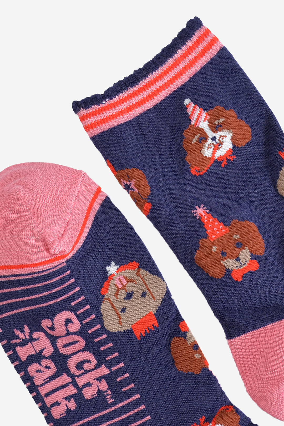 showing the toe and cuff of the socks, the toe is pink with a red border stripe, the cuffs are navy blue with pink and red stripes and a scalloped edge