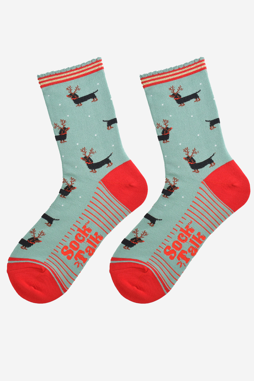 showing the sausage dog reindeer socks laying flat, the soles have red stripes and the dachshund dog pattern is shown to repeat all over the design.