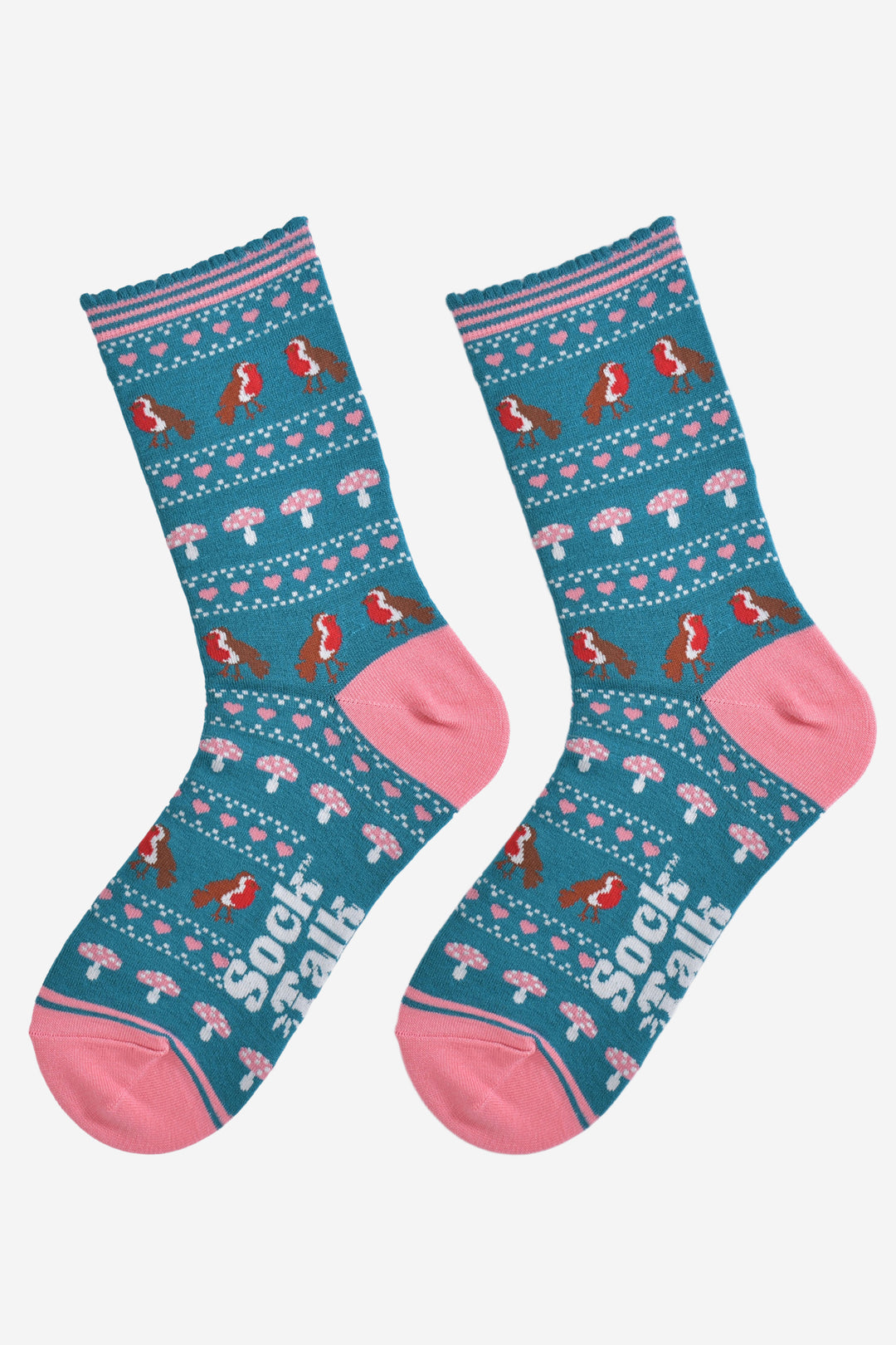 showing the robin fair isle socks laying flat, the heel and toe are pink in contrast to the teal base of the socks. the robin, toadstool and pink heart fair isle pattern is all over the design