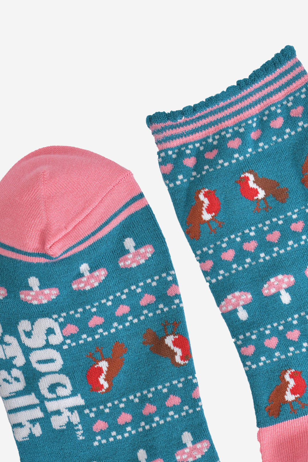 close up of the toe and cuff of the socks, the toe is pink with a pink border stripe, the cuff is scalloped with a teal edge and pink and teal stripes