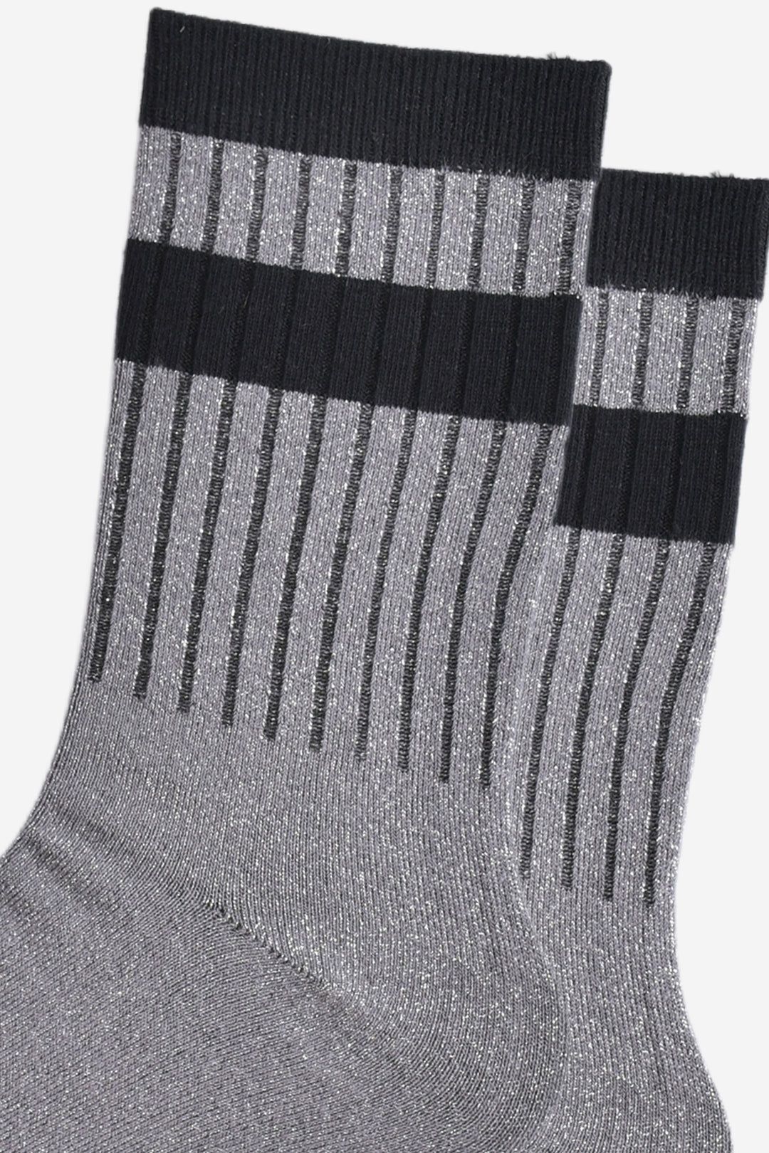 close up of the ribbed sports style cuffs on the socks. they have vertical ribbed details. the base of the socks are grey with a silver glitter sparkle. the cuff is black and there is a horizontal black band stripe, without glitter an inch below the cuff.