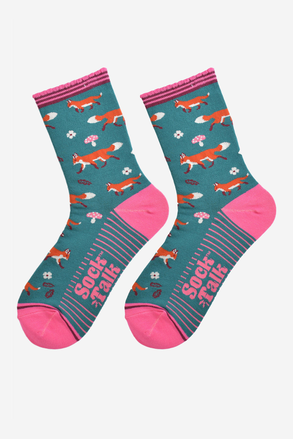 red fox woodland socks laying flat, showing the all over fox, leaf and toad stool pattern and pink accents
