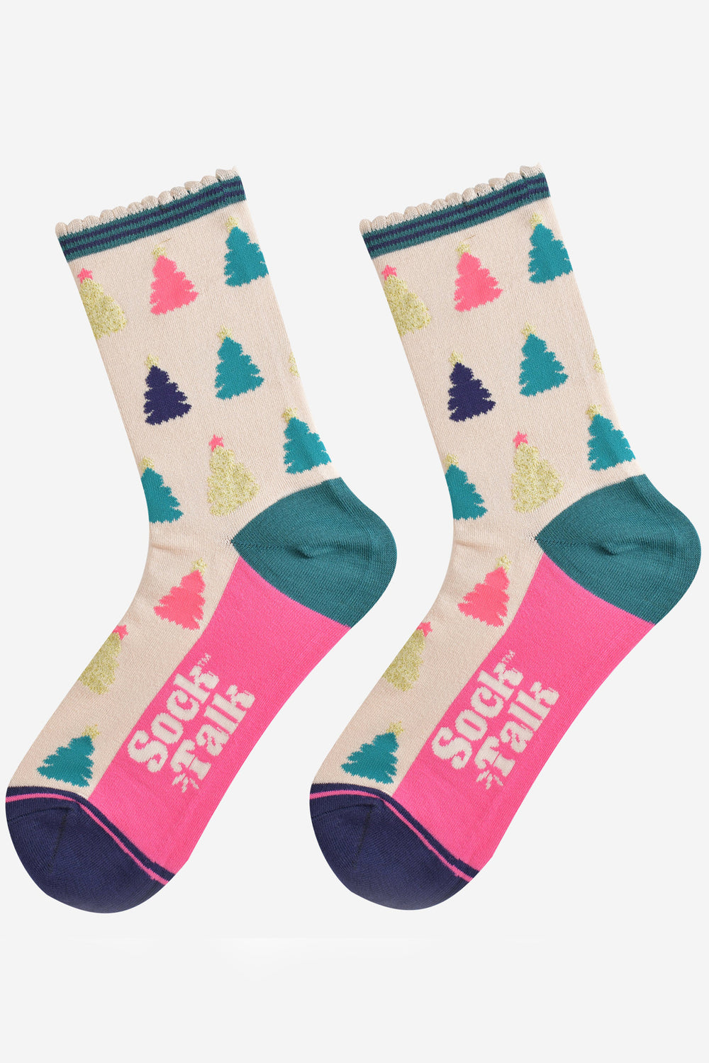 showing the christmas tree socks laying flat, the sole is hot pink in contrast to the cream body of the socks. the xmas tree pattern is all over an in a variety of colours, pink, gold, blue and green