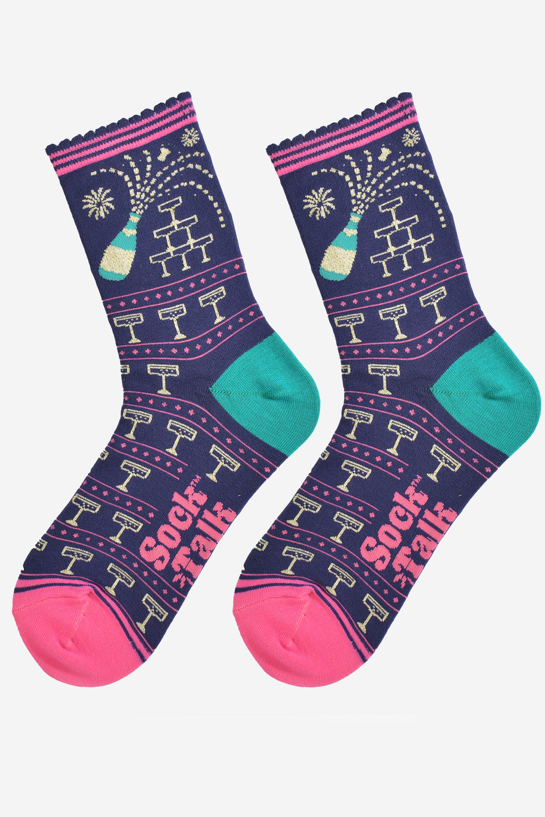 showing the champagne socks laying flat, the champagne glass pattern is all over the design, the toe is pink, the heel is turquoise and the popping champagne bottle is prominent on the ankle of the socks