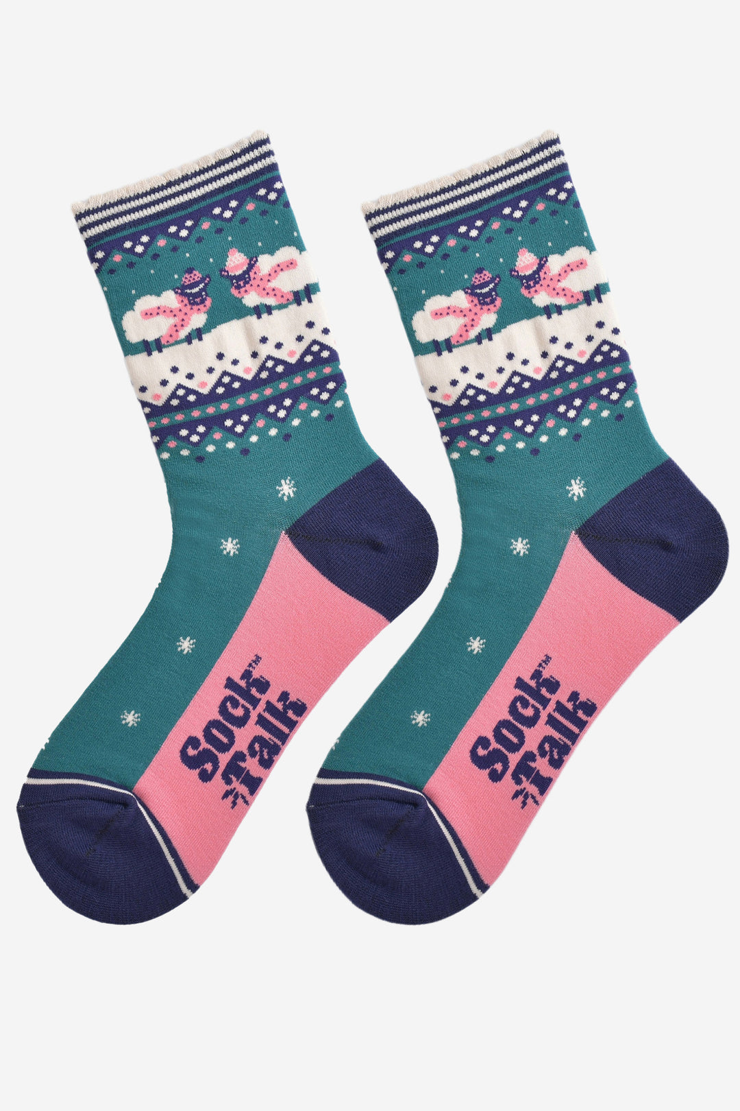 showing the socks laying flat, the soles are pink and the woolly sheep design is prominent on the ankle of the socks. there are stars and zig zag patterns on the socks aswell