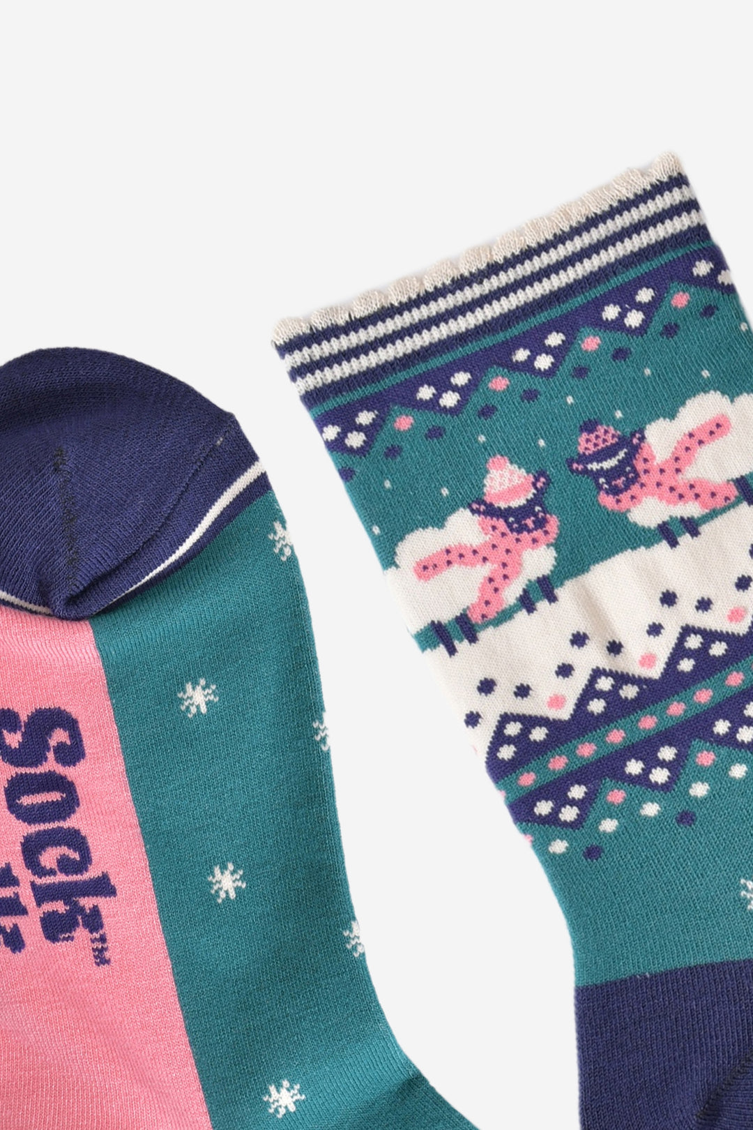 close up of the toe and cuff of the socks, the toe is navy blue and the cuff is cream with navy stripes and a scalloped edge